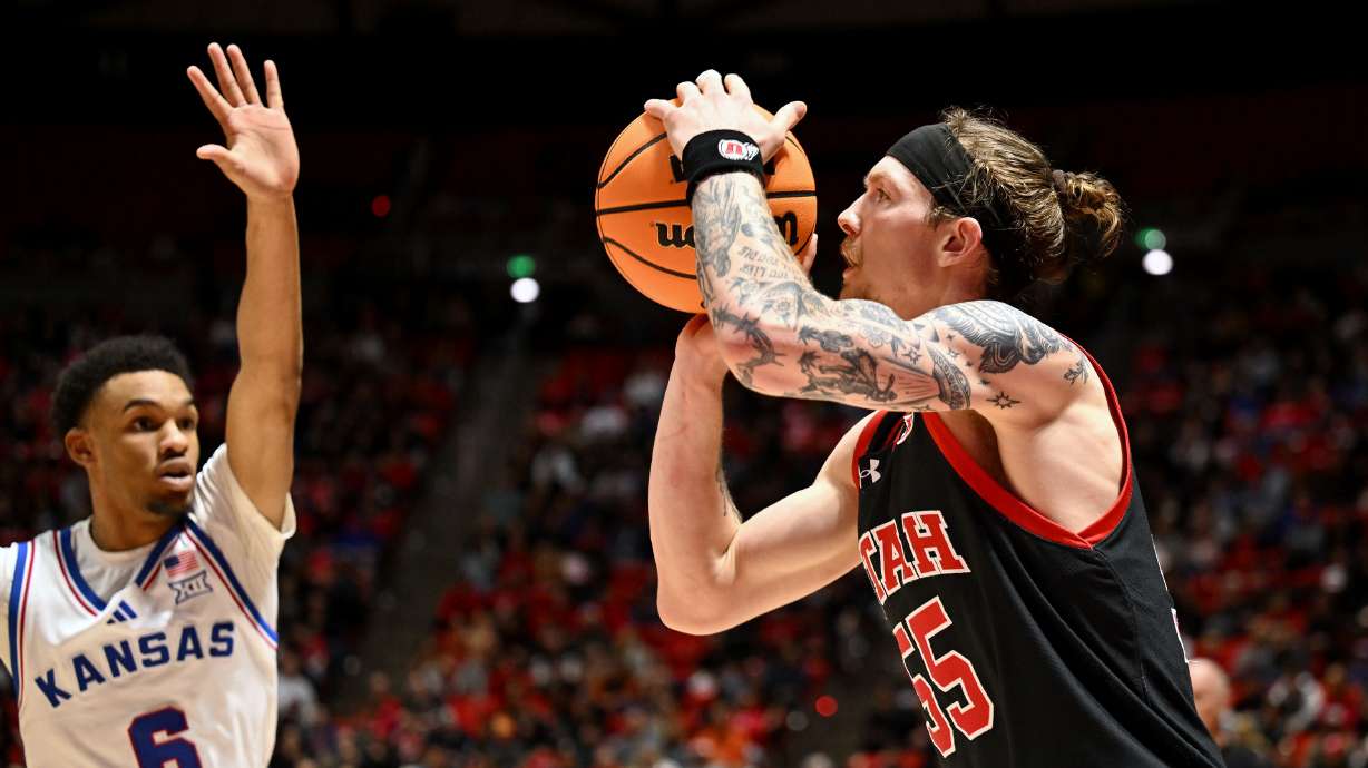 Utah Utes guard Gabe Madsen (55) puts up a shot with Kansas Jayhawks guard Rylan Griffen (6) running to defend as Utah and Kansas play in Salt Lake City, at the Huntsman Center on Saturday February 15, 2025.