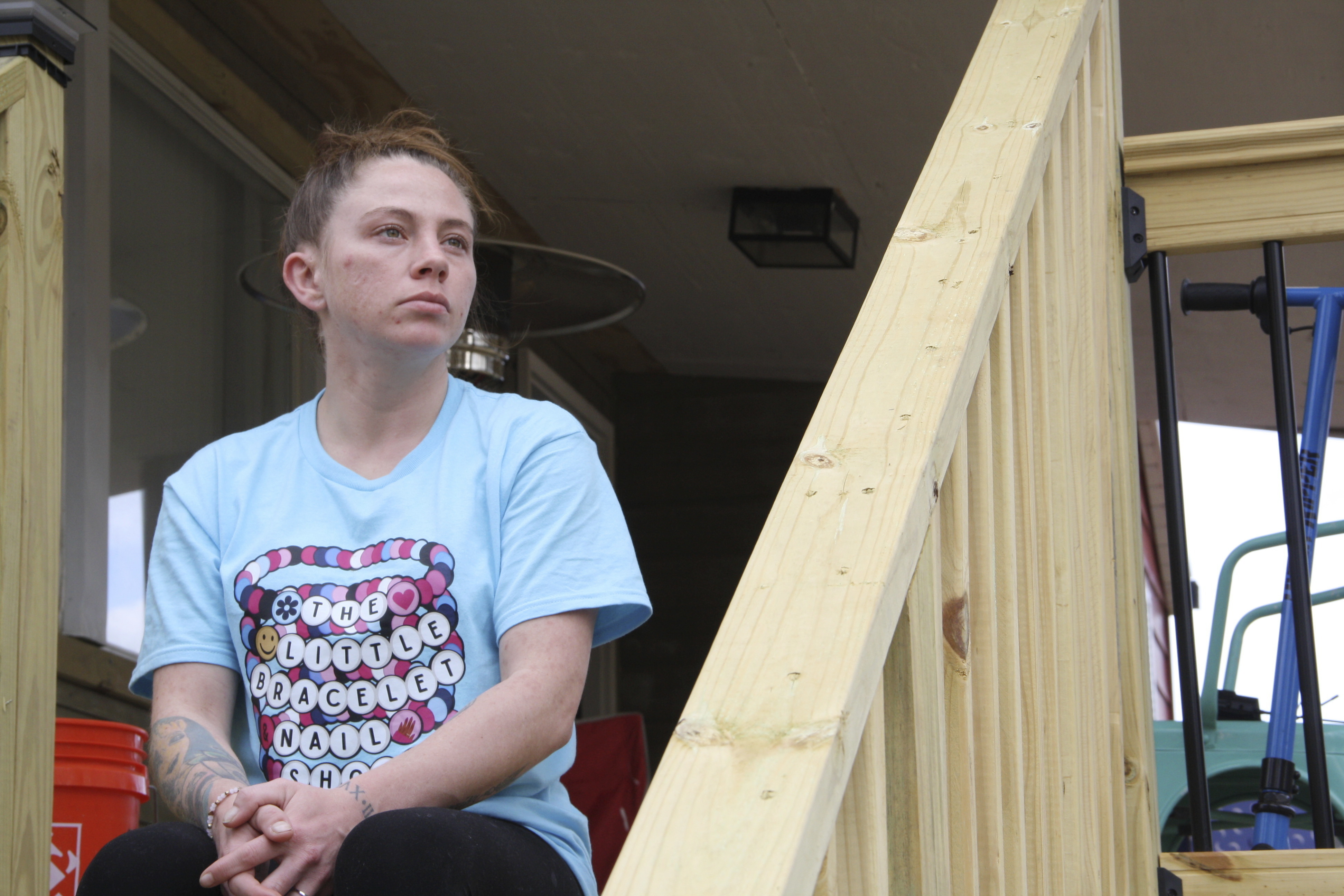 Emily Russell sits on the newly constructed staircase leading up to the front of her home in Swannanoa, N.C., on Feb. 6.