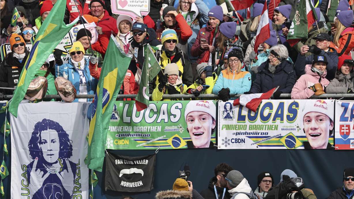 Brazilian fans cheer on Brazil's Lucas Pinheiro Braathen at the finish area of a men's giant slalom, at the Alpine Ski World Championships, in Saalbach-Hinterglemm, Austria, Friday, Feb. 14, 2025.
