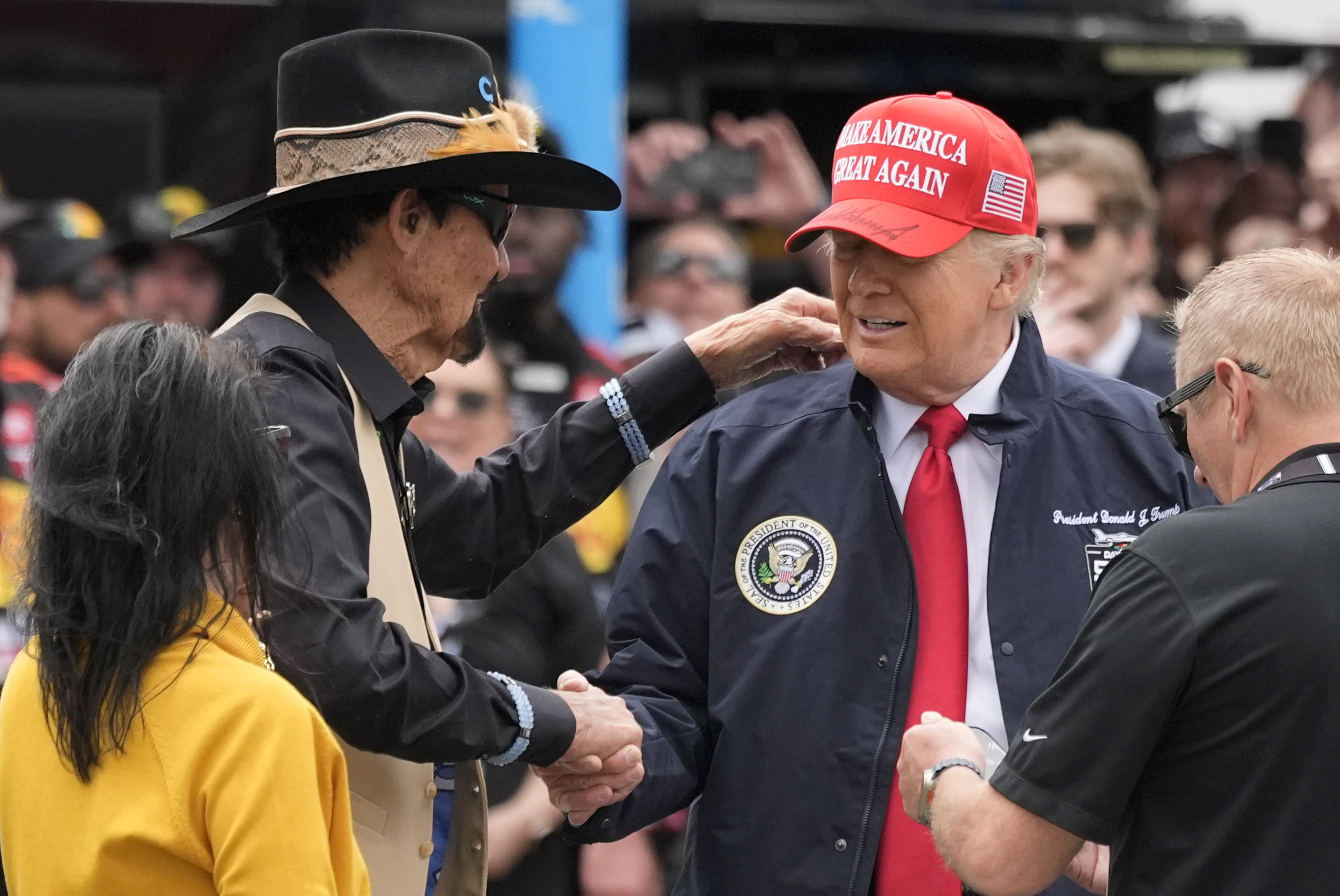 President Donald Trump, right, shakes hands with NASCAR Hall of Fame driver Richard Petty at the NASCAR Daytona 500 auto race at Daytona International Speedway, Sunday, Feb. 16, 2025, in Daytona Beach, Fla.