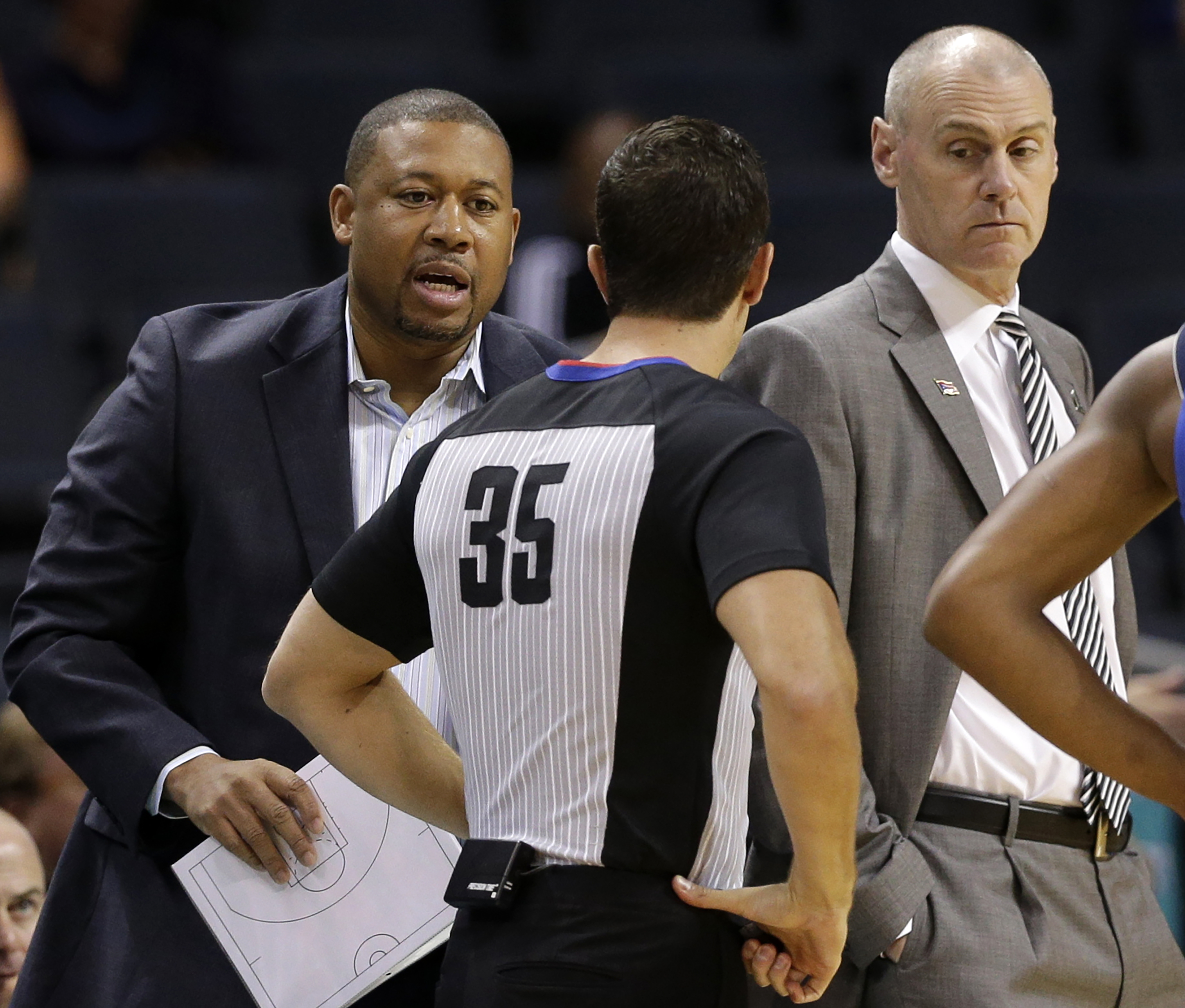 FILE - Dallas Mavericks head coach Rick Carlisle, right, and assistant coach Darrell Armstrong argue a call with an official in the first half of a preseason NBA basketball game against the Charlotte Hornets in Charlotte, N.C., Oct. 13, 2017.