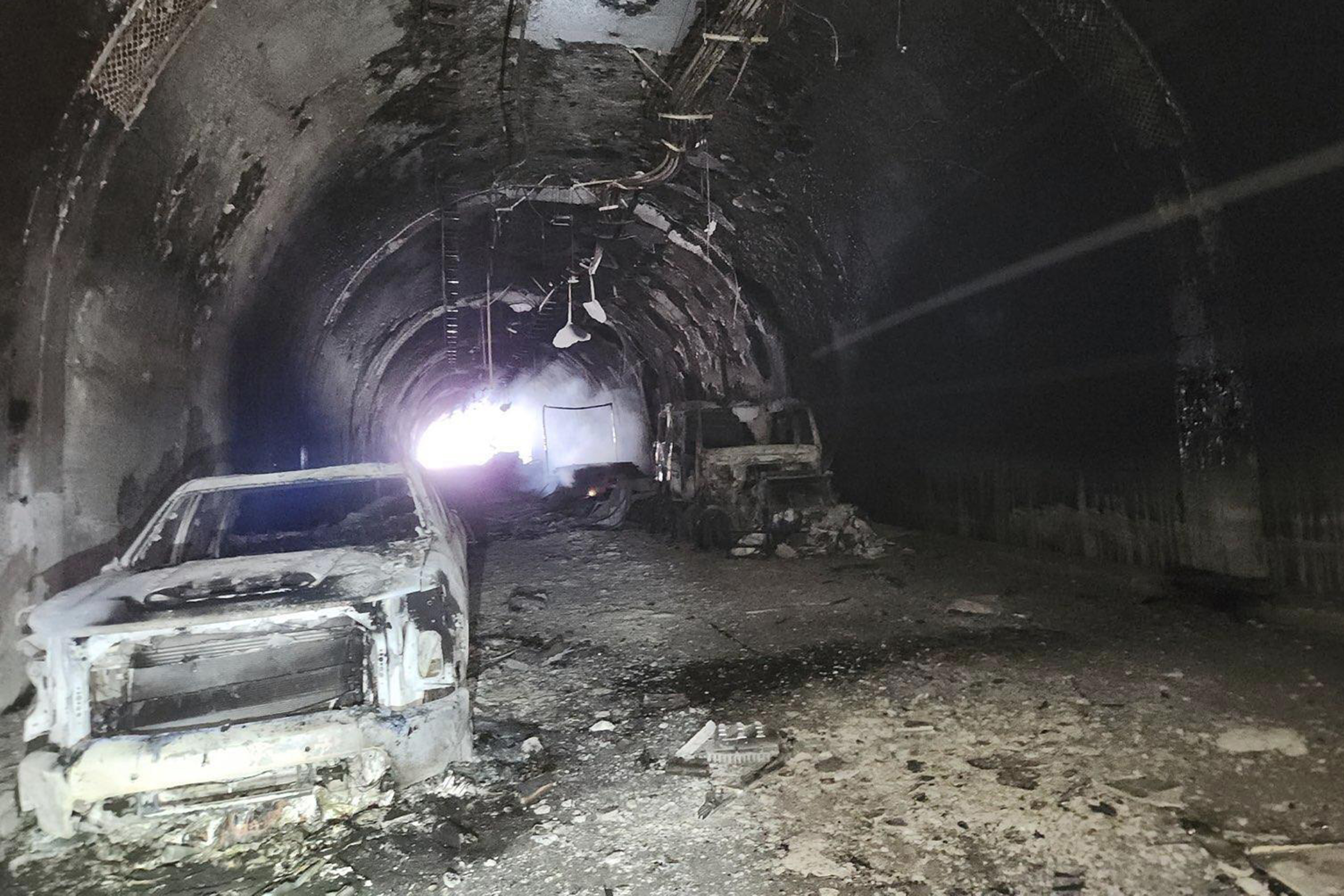 Charred vehicles are seen after a Friday accident and fire in the Green River Tunnel along Interstate 80, Saturday, in Green River, Wyo.