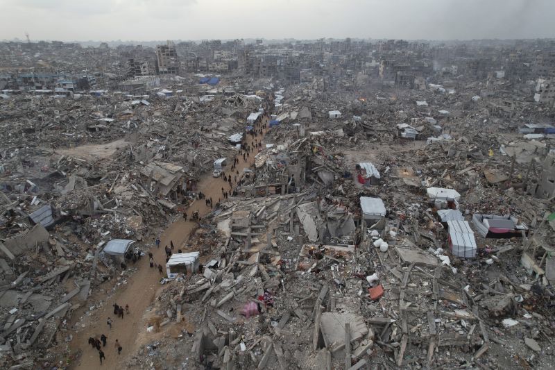 An aerial photograph taken by a drone shows people walking between the destruction caused by the Israeli air and ground offensive in Jabaliya, Gaza Strip, on Sunday.