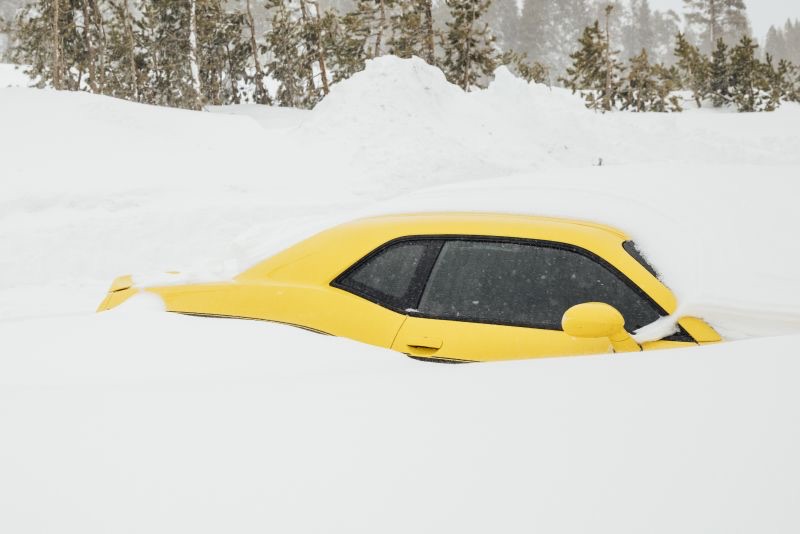 A Dodge Challenger is seen buried in snow near Soda Springs, Calif., Friday.