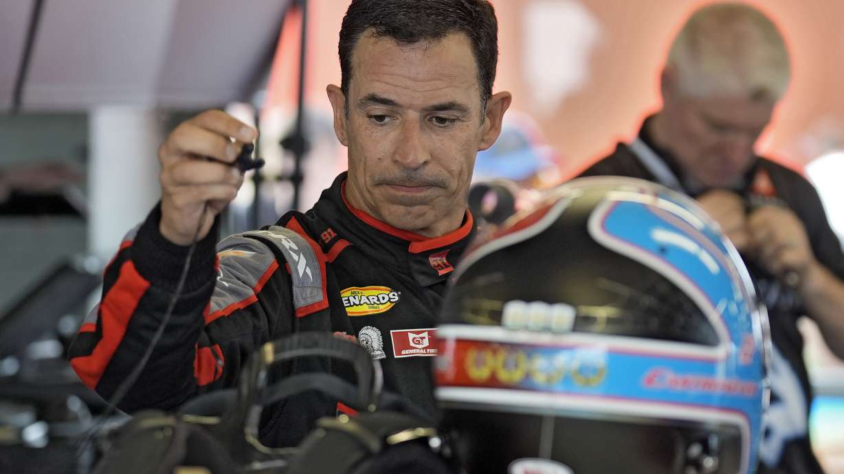 Helio Castroneves, of Brazil, gets his helmet ready during a practice for the NASCAR Daytona 500 auto race Saturday, Feb. 15, 2025, at Daytona International Speedway in Daytona Beach, Fla.