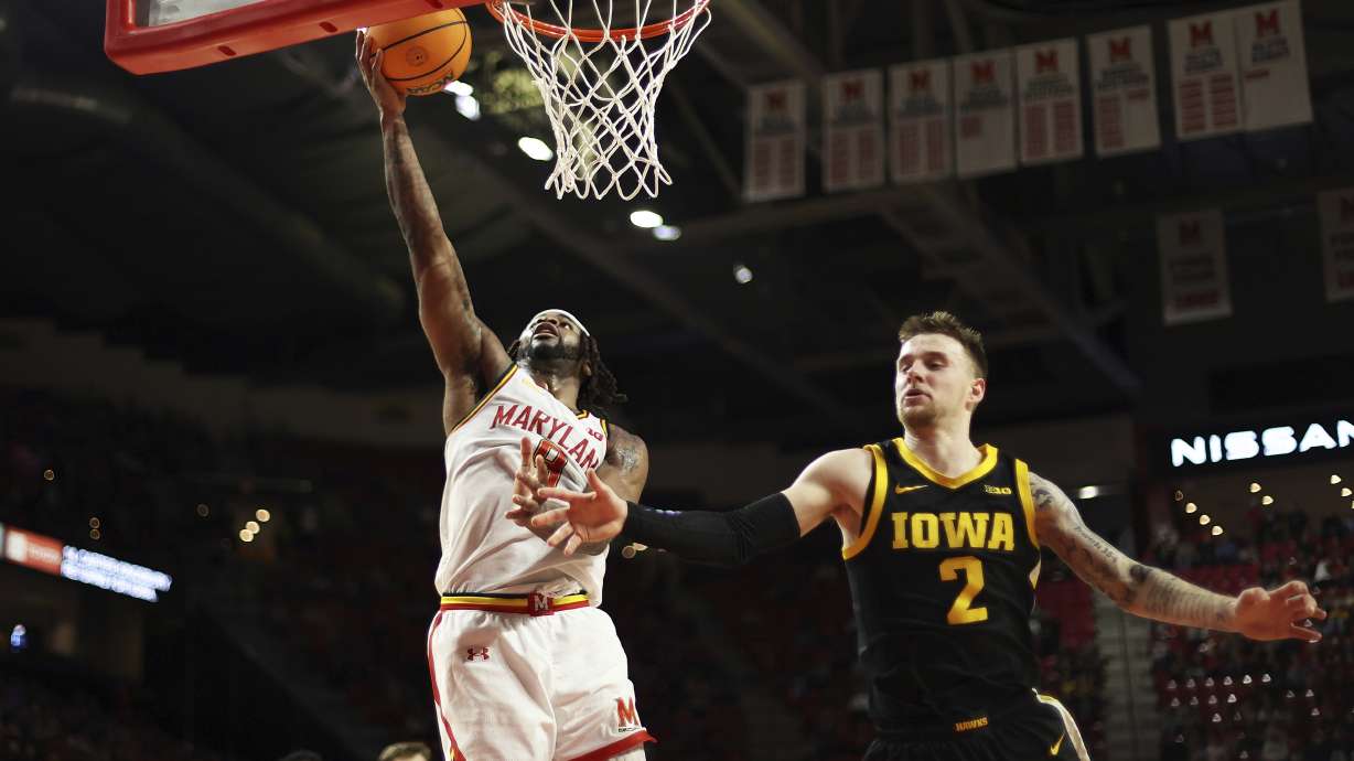 Maryland guard Selton Miguel takes a shot over Iowa guard Brock Harding (2) during the second half of an NCAA college basketball game, Sunday, Feb. 16, 2025, in College Park, Md.