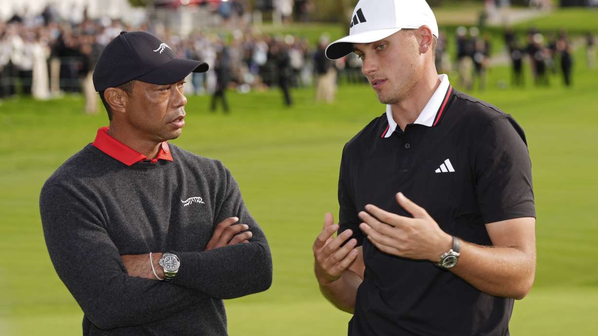 Ludvig Ã…berg, of Sweden, right, speaks with Tiger Woods after winning the Genesis Invitational golf tournament Sunday, Feb. 16, 2025, in San Diego.