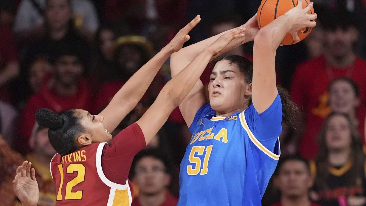UCLA center Lauren Betts, right, tries to pass while under pressure from Southern California guard JuJu Watkins during the second half of an NCAA college basketball game, Thursday, Feb. 13, 2025, in Los Angeles.