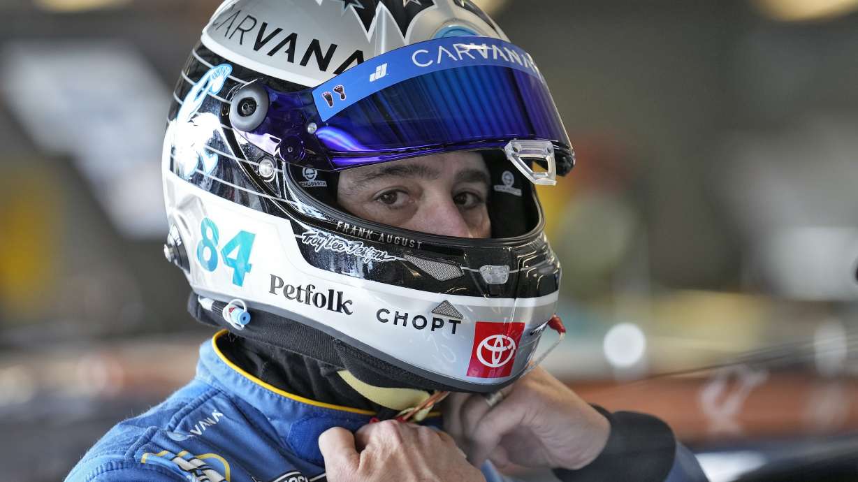 Jimmie Johnson finishes putting on his helmet before a practice for the NASCAR Daytona 500 auto race Wednesday, Feb. 12, 2025, at Daytona International Speedway in Daytona Beach, Fla.