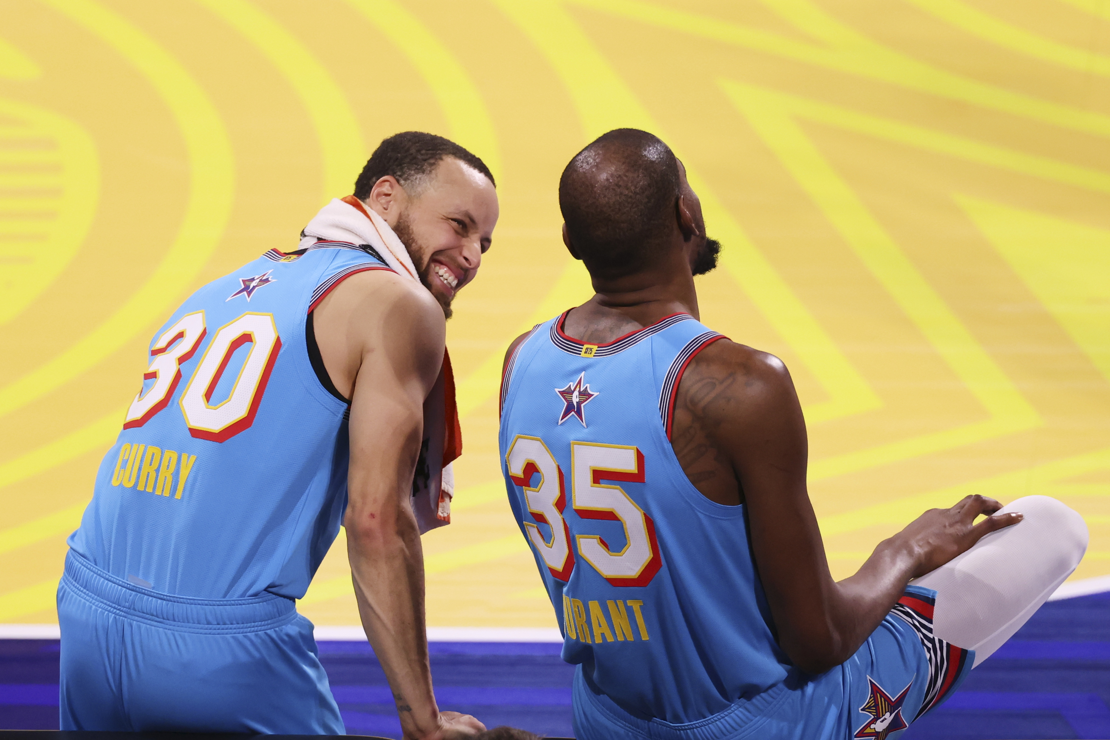 Golden State Warriors guard Stephen Curry talks to Phoenix Suns forward Kevin Durant during the NBA All-Star basketball game Sunday, Feb. 16, 2025, in San Francisco.