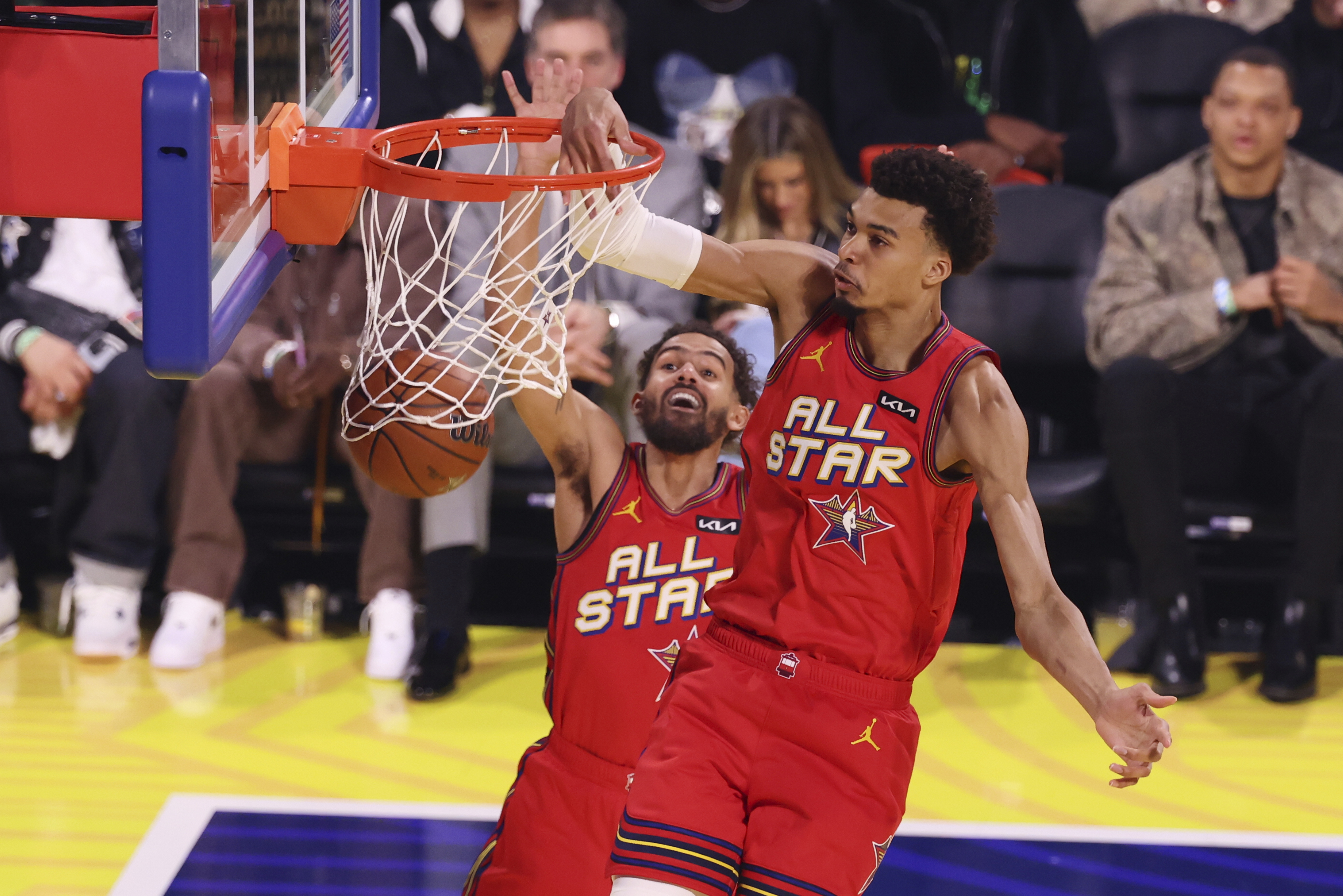 San Antonio Spurs center Victor Wembanyama dunks past teammate Trae Young during the NBA All-Star basketball game Sunday, Feb. 16, 2025, in San Francisco.