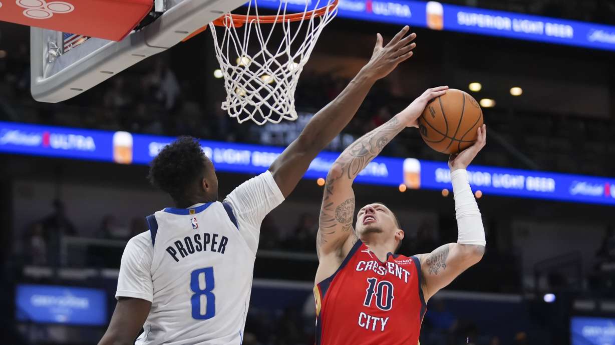 New Orleans Pelicans center Daniel Theis (10) goes to the basket against Dallas Mavericks forward Olivier-Maxence Prosper (8) in the first half of an NBA basketball game in New Orleans, Wednesday, Jan. 29, 2025.