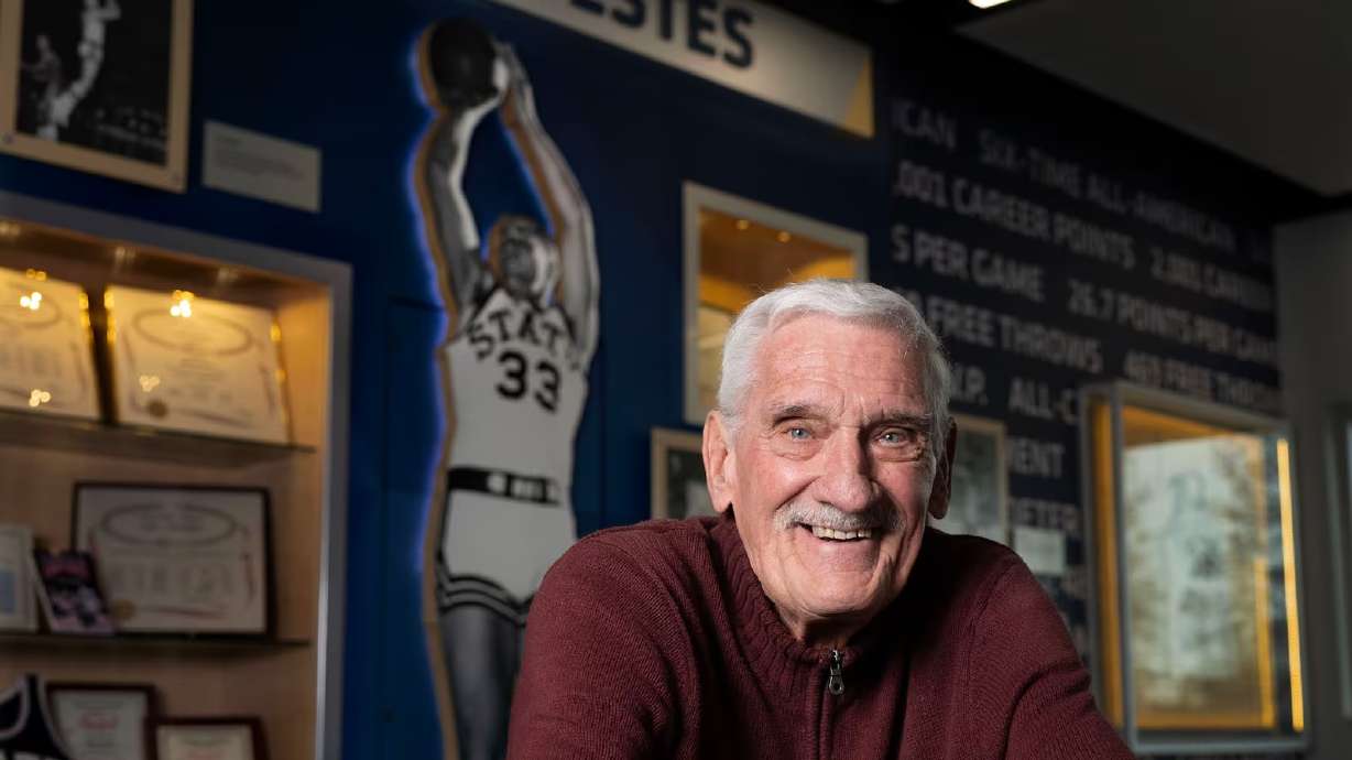 Del Lyons, friend, roommate and teammate of Wayne Estes, poses for picture in the Wayne Estes Center at Utah State University in Logan on Friday, Jan. 17, 2025.