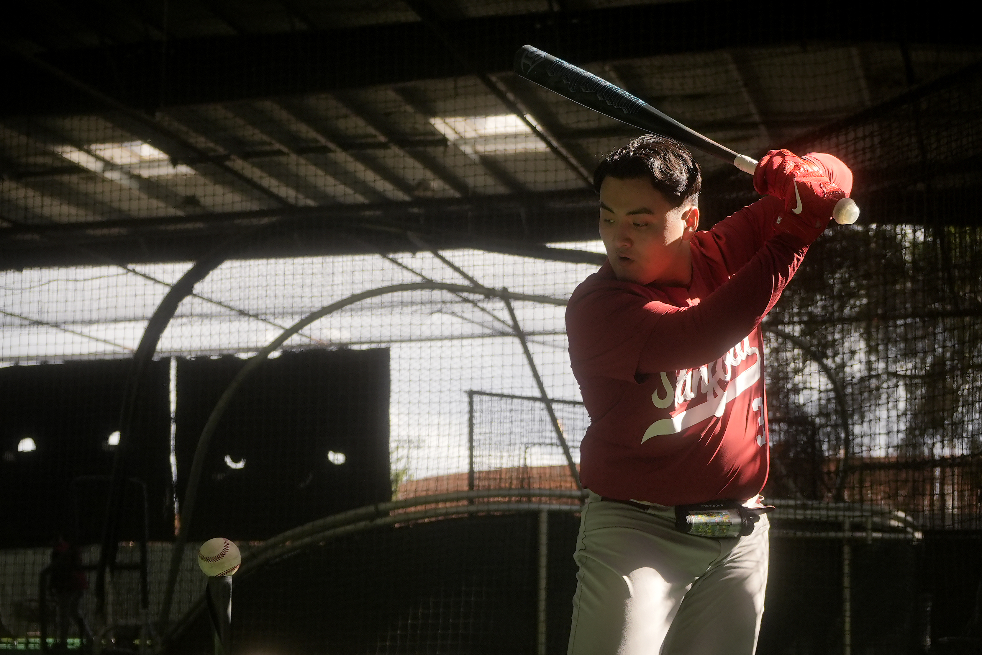 Stanford baseball player Rintaro Sasaki swings in the batting cage area at the Sunken Diamond baseball field at Stanford University in Stanford, Calif., Friday, Feb. 7, 2025.