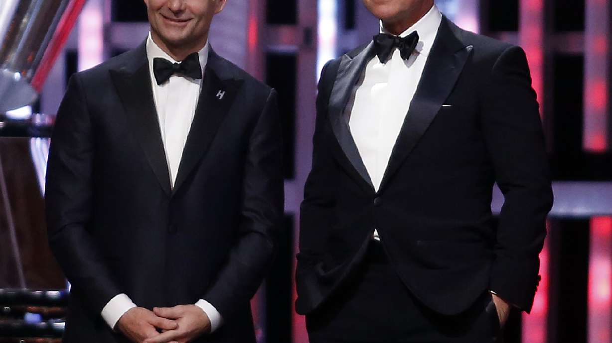 FILE - Jeff Gordon, left, and Tom Cruise listen on stage during the NASCAR Sprint Cup Series auto racing awards, Dec. 4, 2015, in Las Vegas.