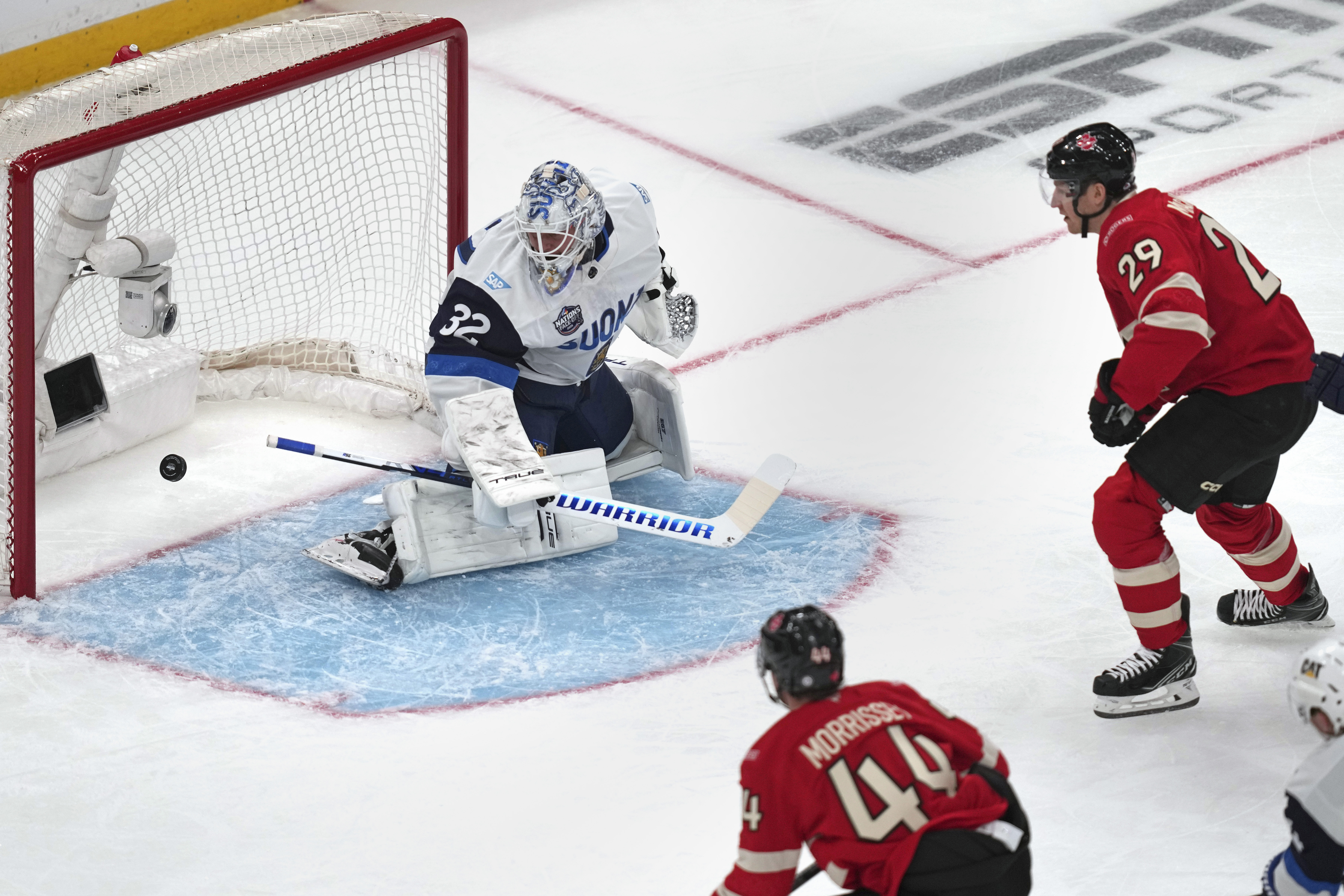 Canada's Nathan MacKinnon scores on Finland's Kevin Lankinen during the first period of a 4 Nations Face-Off hockey game, Monday, Feb. 17, 2025, in Boston.