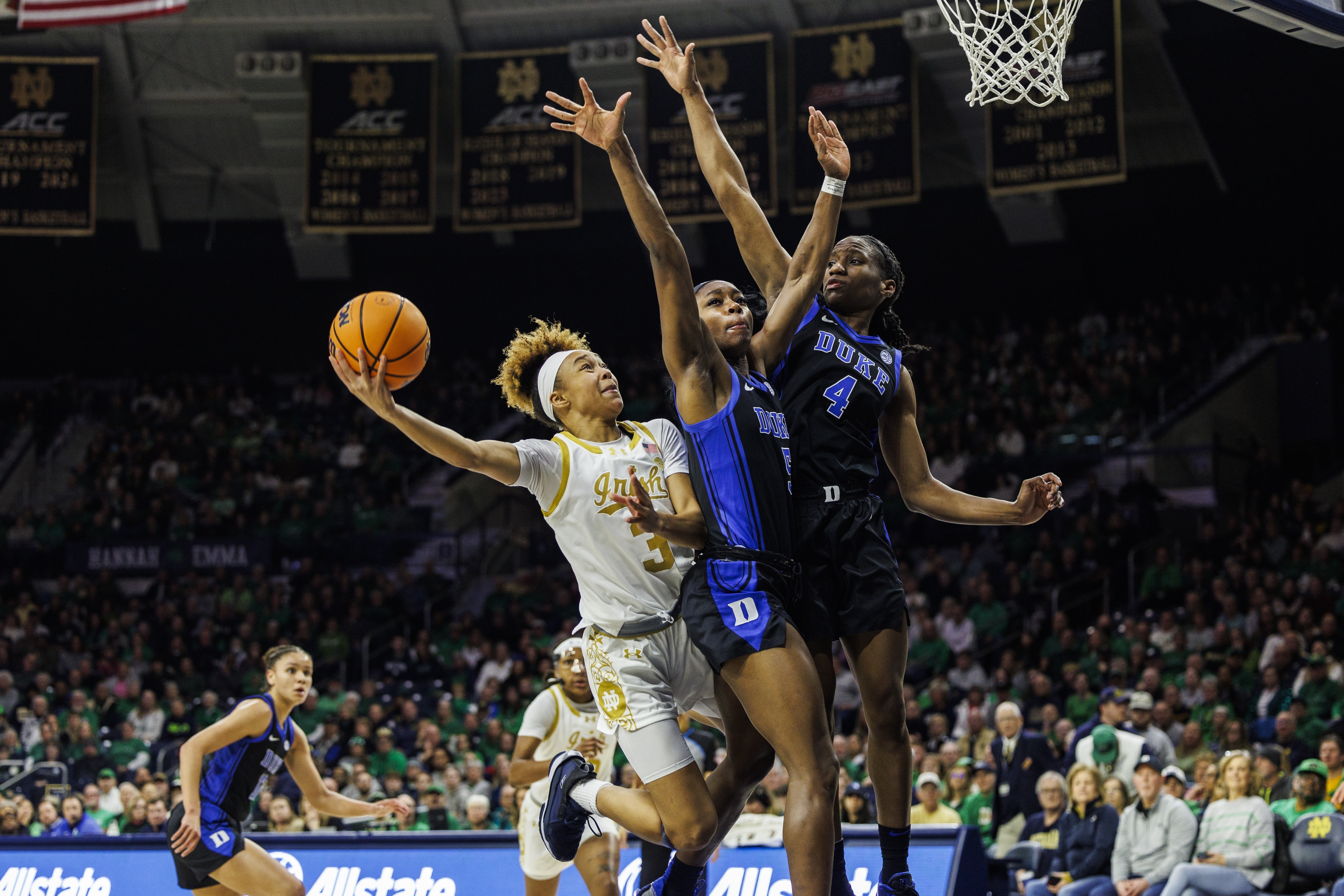Notre Dame guard Hannah Hidalgo (3) shoots as Duke guard Oluchi Okananwa (5) and Duke guard Jadyn Donovan (4) defend during the first half of an NCAA college basketball game, Monday, Feb. 17, 2025, in South Bend, Ind.