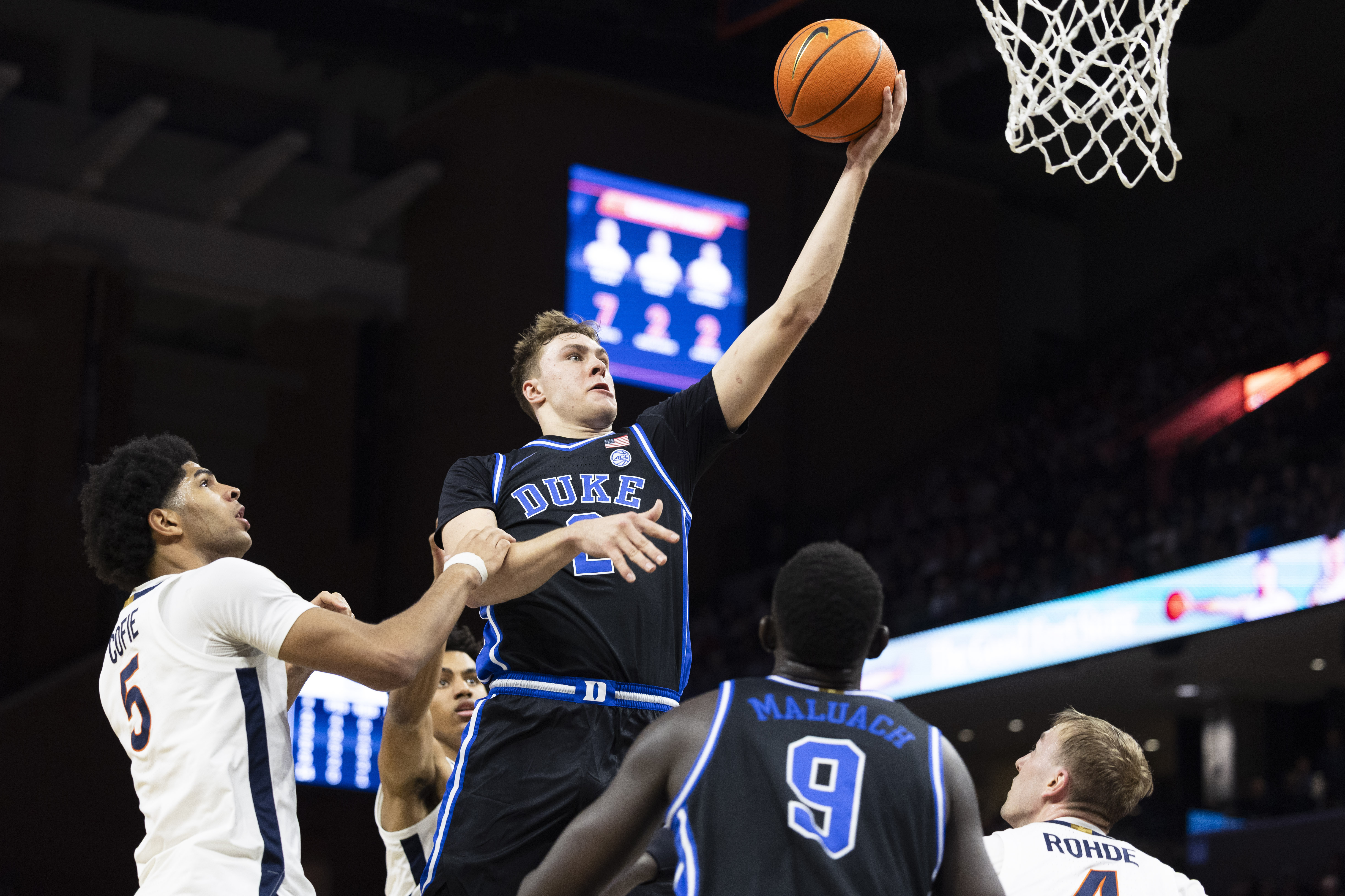 Duke guard Cooper Flagg shoots the ball past Virginia forward Jacob Cofie (5) during the first half of an NCAA college basketball game, Monday, Feb. 17, 2025, in Charlottesville, Va.