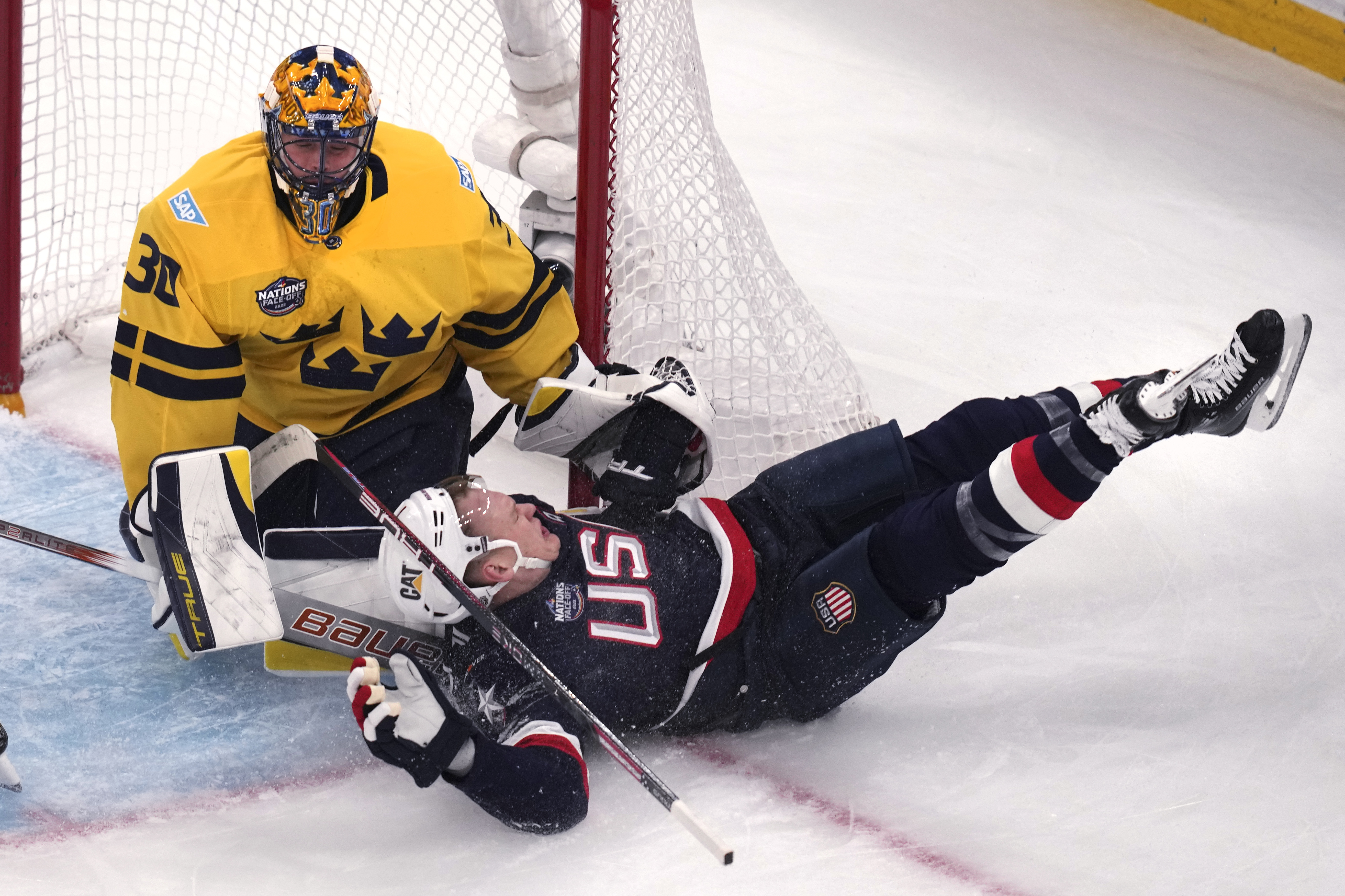 United States' Brady Tkachuk slams into the post while chasing the puck towards Sweden goaltender Samuel Ersson during the first period of a 4 Nations Face-Off hockey game, Monday, Feb. 17, 2025, in Boston.