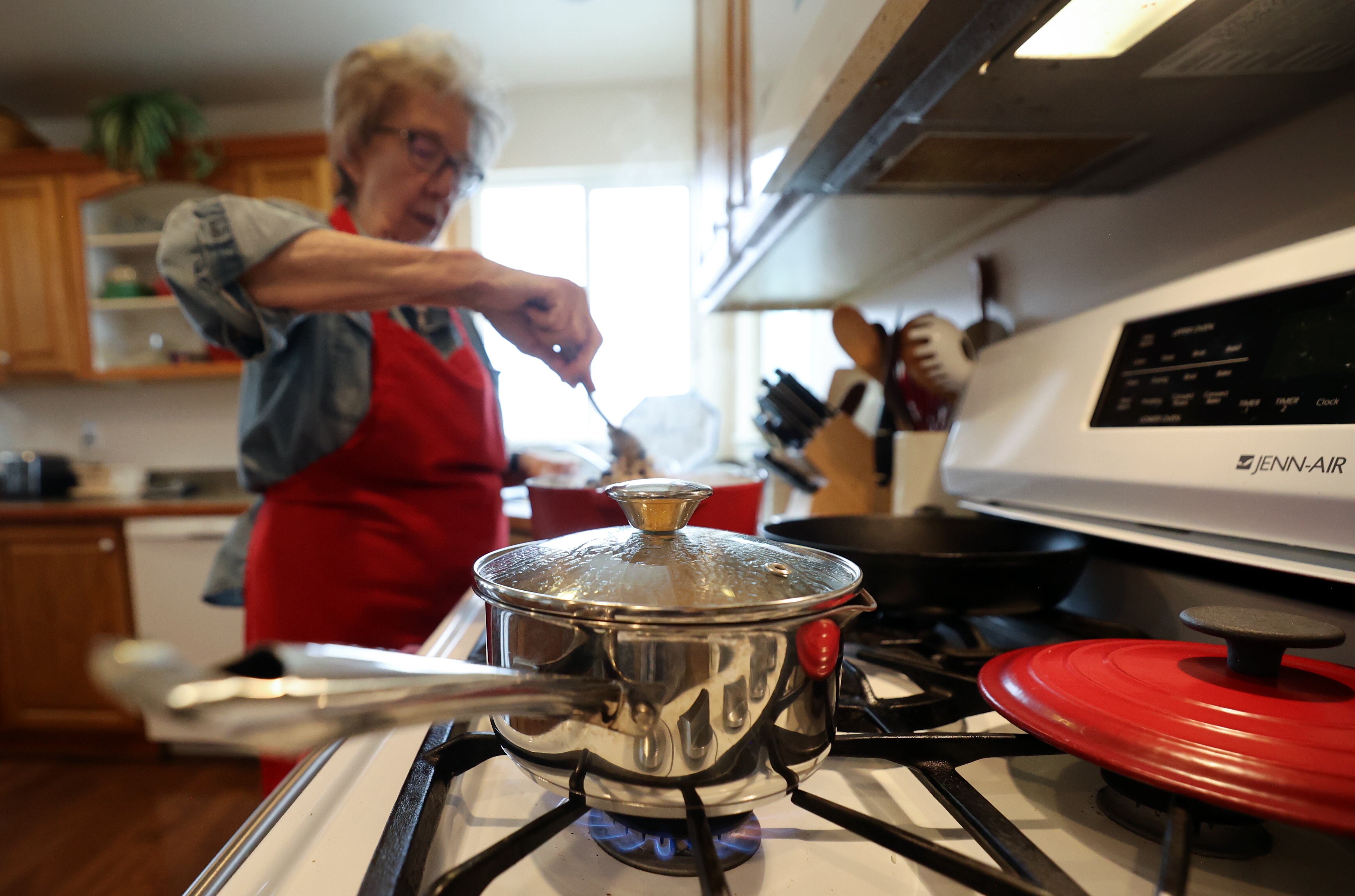 Deanna Buck uses her gas stove to cook lunch at home in Hooper on Feb. 13. The Trump administration's energy policies are reversing actions on energy by the previous administration.