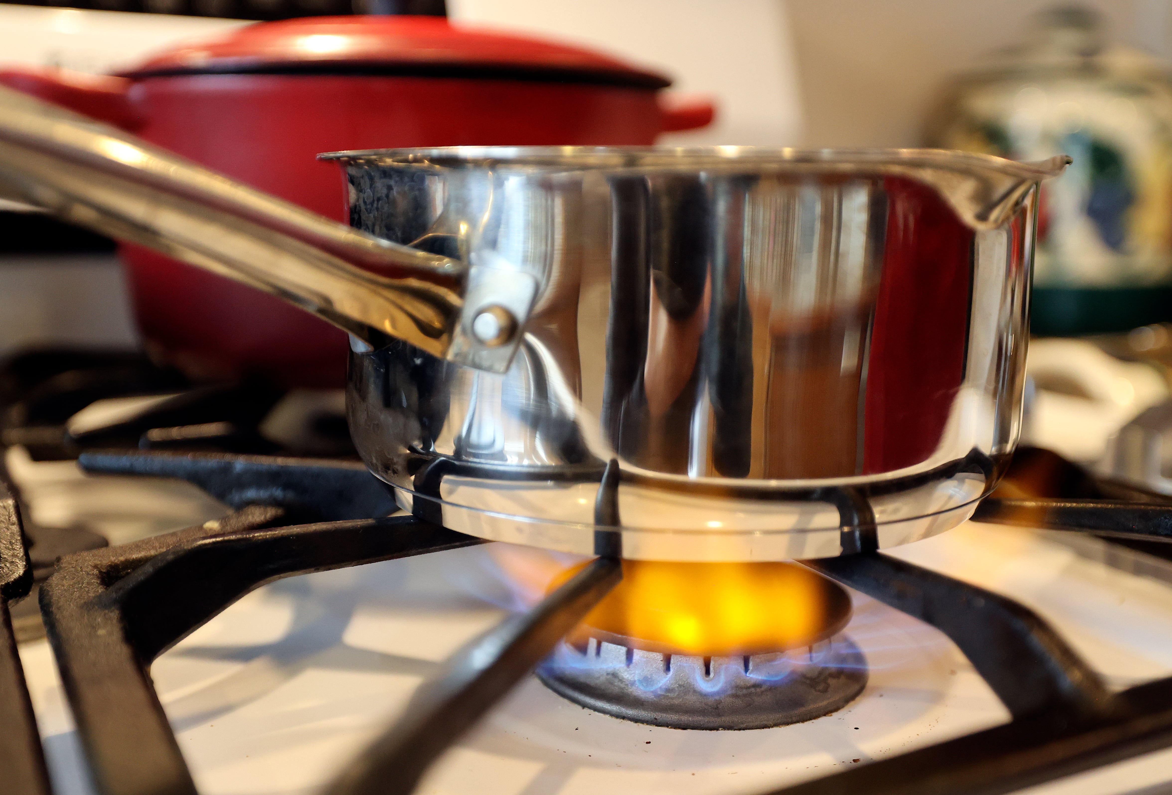 A gas stove flame heats a pot at Deanna Buck’s home in Hooper on Feb. 13.