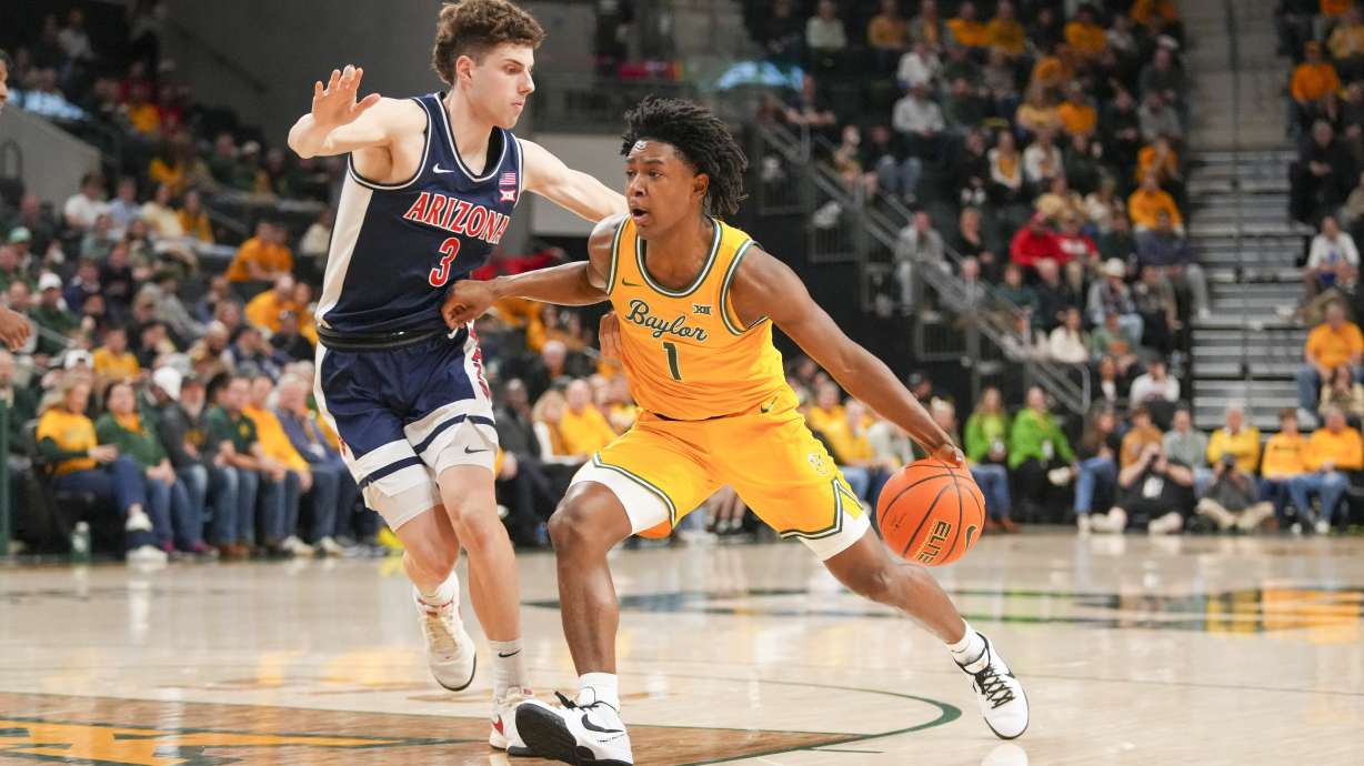 Baylor guard Robert Wright III (1) drives to the basket against Arizona guard Anthony Dell'Orso (3) during the first half of an NCAA college basketball game Monday, Feb. 17, 2025, in Waco, Texas.