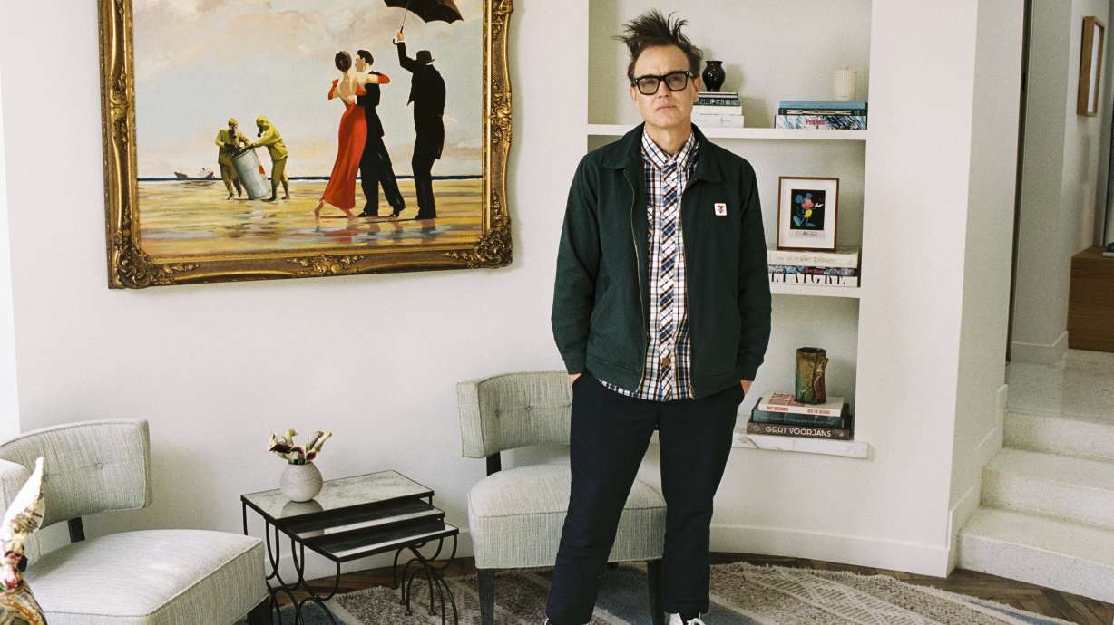 In an undated image, Mark Hoppus of Blink-182 poses by his painting Crude Oil (Vettriano) by Banksy, which is being sold by Sotheby's on March 4 with some of the proceeds going to victims of the Los Angeles wildfires.