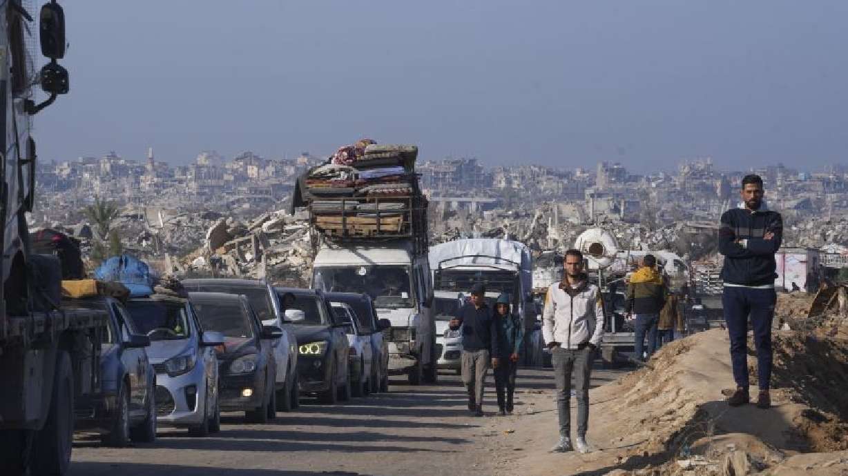 Displaced Palestinians, traveling in vehicles, wait to cross through a security checkpoint at the Netzarim corridor as they make their way from central Gaza to the northern Gaza Strip, Tuesday. A senior Hamas leader says the militant group will release six living Israeli hostages on Saturday.