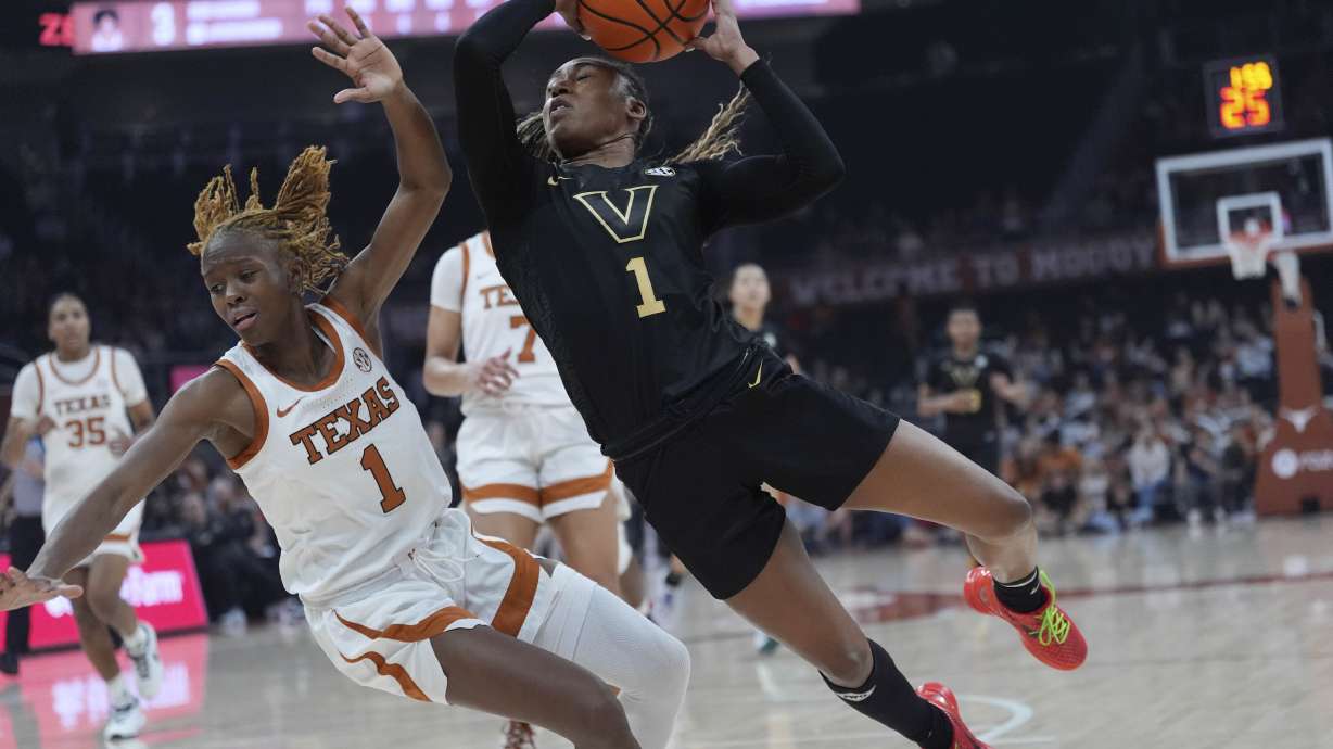Vanderbilt guard Mikayla Blakes, right, is fouled by Texas guard Bryanna Preston, left, as she drives to the basket during the first half of an NCAA college basketball game in Austin, Texas, Thursday, Feb. 6, 2025.