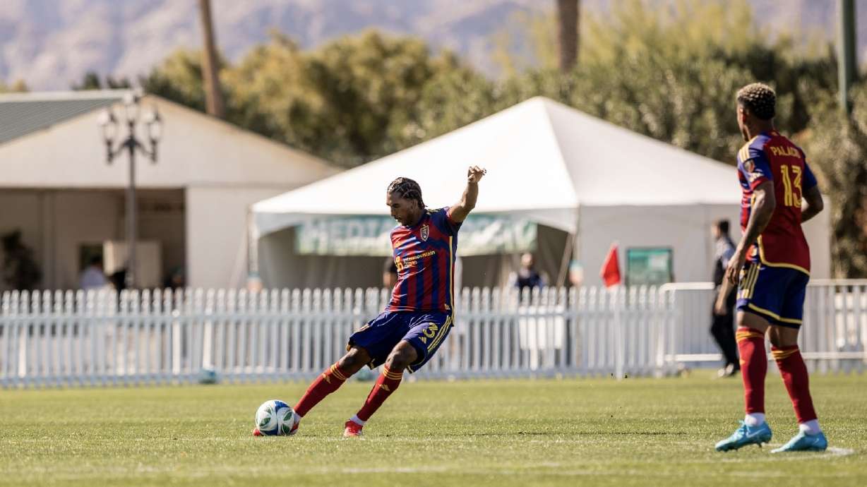 Kobi Henry, left, sends off a long pass for RSL.