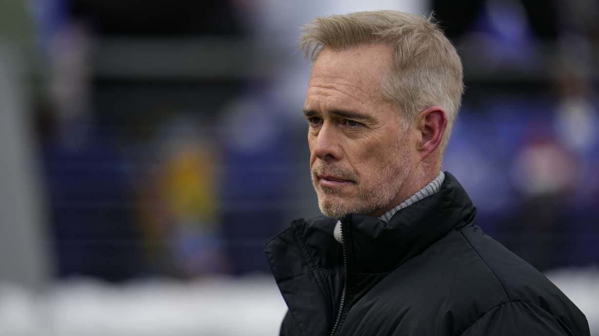 FILE - ESPN broadcaster Joe Buck walks the field before an NFL football AFC divisional playoff game between the Baltimore Ravens and the Houston Texans, Saturday, Jan. 20, 2024, in Baltimore.