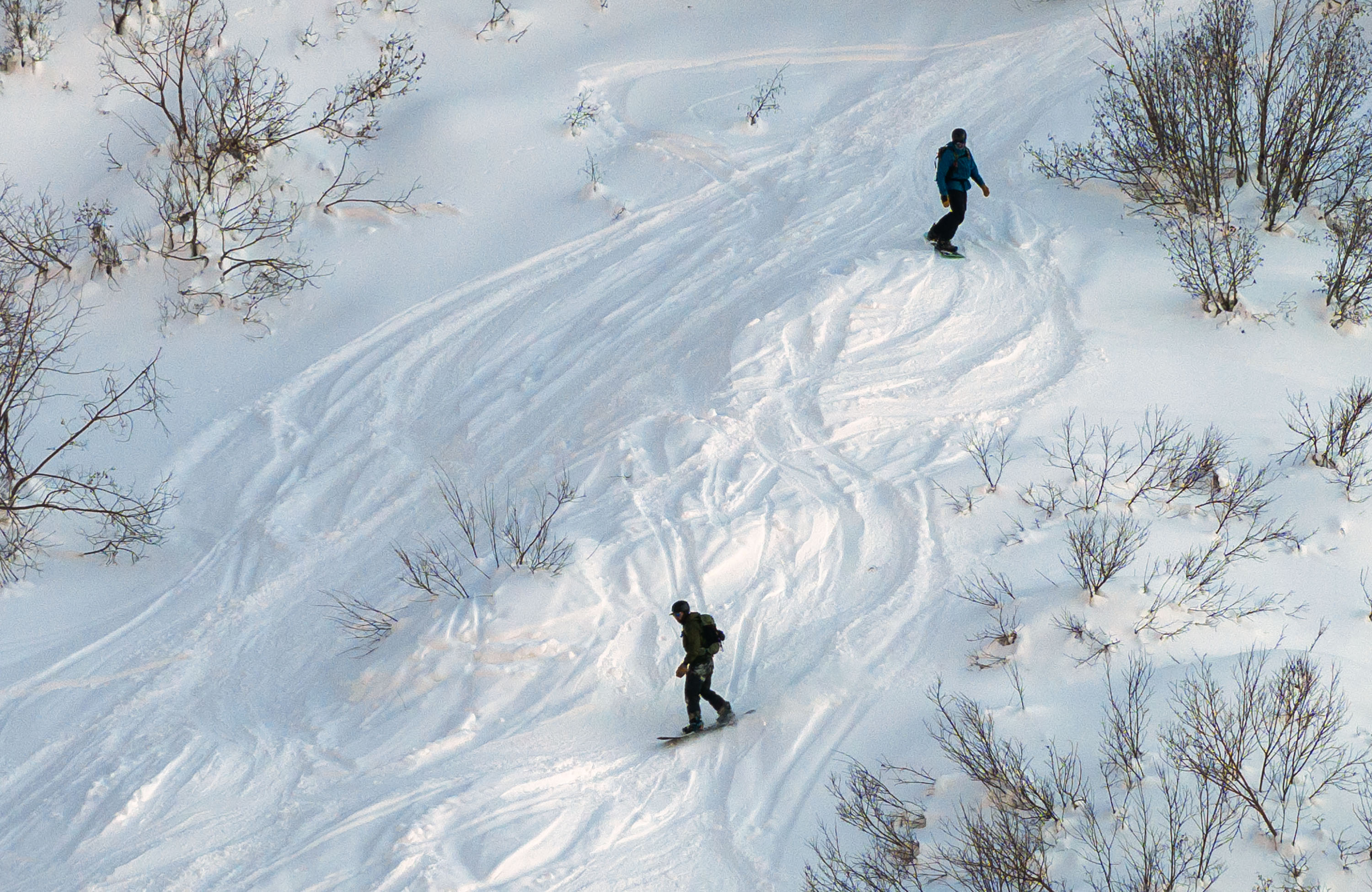 Snowboarders ride the snow in Little Cottonwood Canyon on Jan. 26. Utah's snowpack will get at least one more boost before warmer and drier conditions return, but the next storm could also cause some commute impacts.