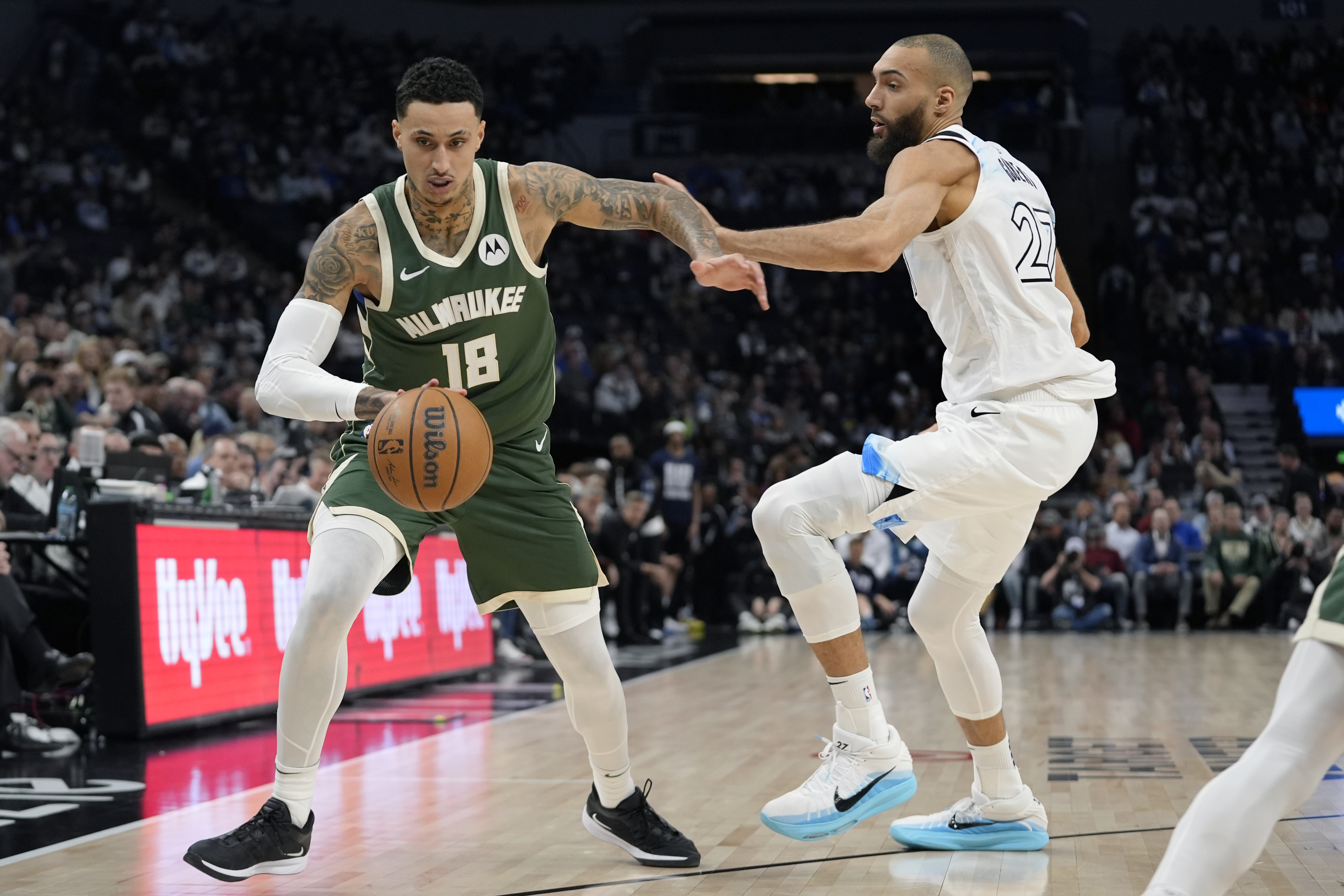 Milwaukee Bucks forward Kyle Kuzma (18) works toward the basket as Minnesota Timberwolves center Rudy Gobert (27) defends during the first half of an NBA basketball game, Wednesday, Feb. 12, 2025, in Minneapolis.