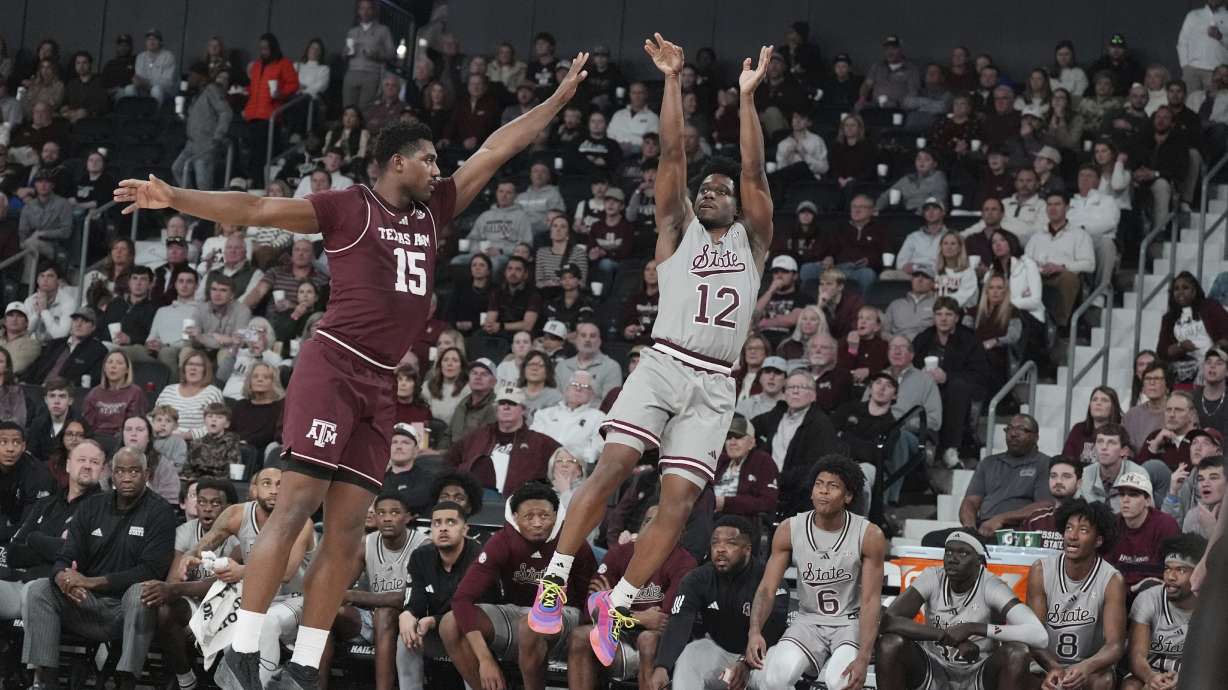 Mississippi State guard Josh Hubbard (12) shoots a three-point shot while Texas A&M forward Henry Coleman III (15) attempts to block during the second half of an NCAA college basketball game, Tuesday, Feb. 18, 2025, in Starkville, Miss.