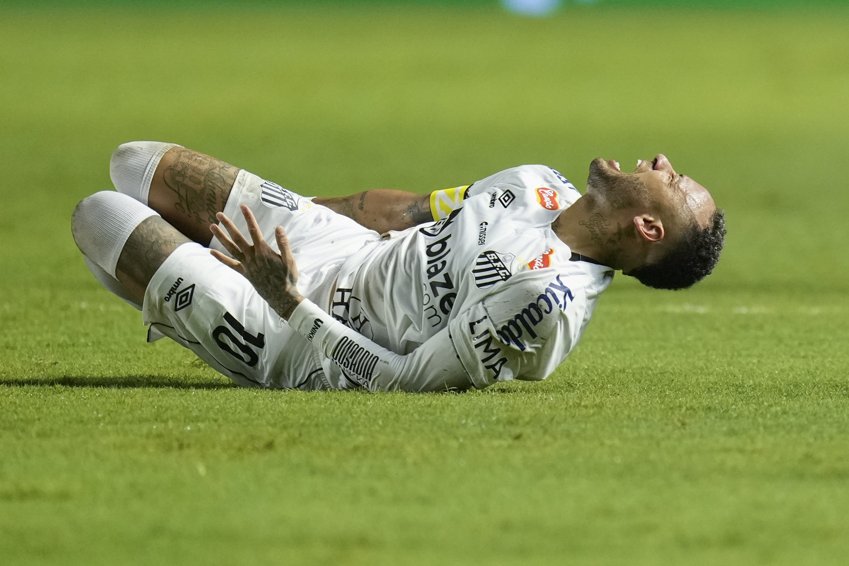 Brazil's Neymar grimaces in pain after he was fouled during his debut for Santos FC in a Sao Paulo league soccer match, against Botafogo-SP in Santos, Brazil, Wednesday, Feb. 5, 2025.