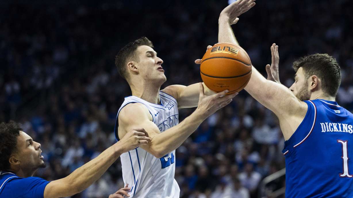 Brigham Young Cougars guard Trevin Knell (21) attempts to drive the ball to the basket during a game between BYU and the Kansas Jayhawks at the Marriott Center on the campus of BYU in Provo on Tuesday, Feb. 18, 2025.