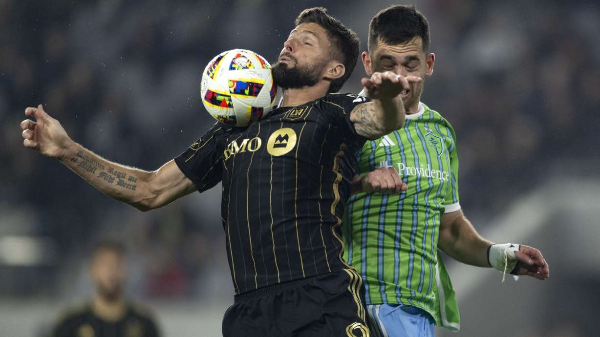FILE - Los Angeles FC forward Olivier Giroud, left, controls the ball in front of Seattle Sounders defender Jackson Ragen during the second half of an MLS Western Conference semifinal soccer match in Los Angeles, Nov. 23, 2024.
