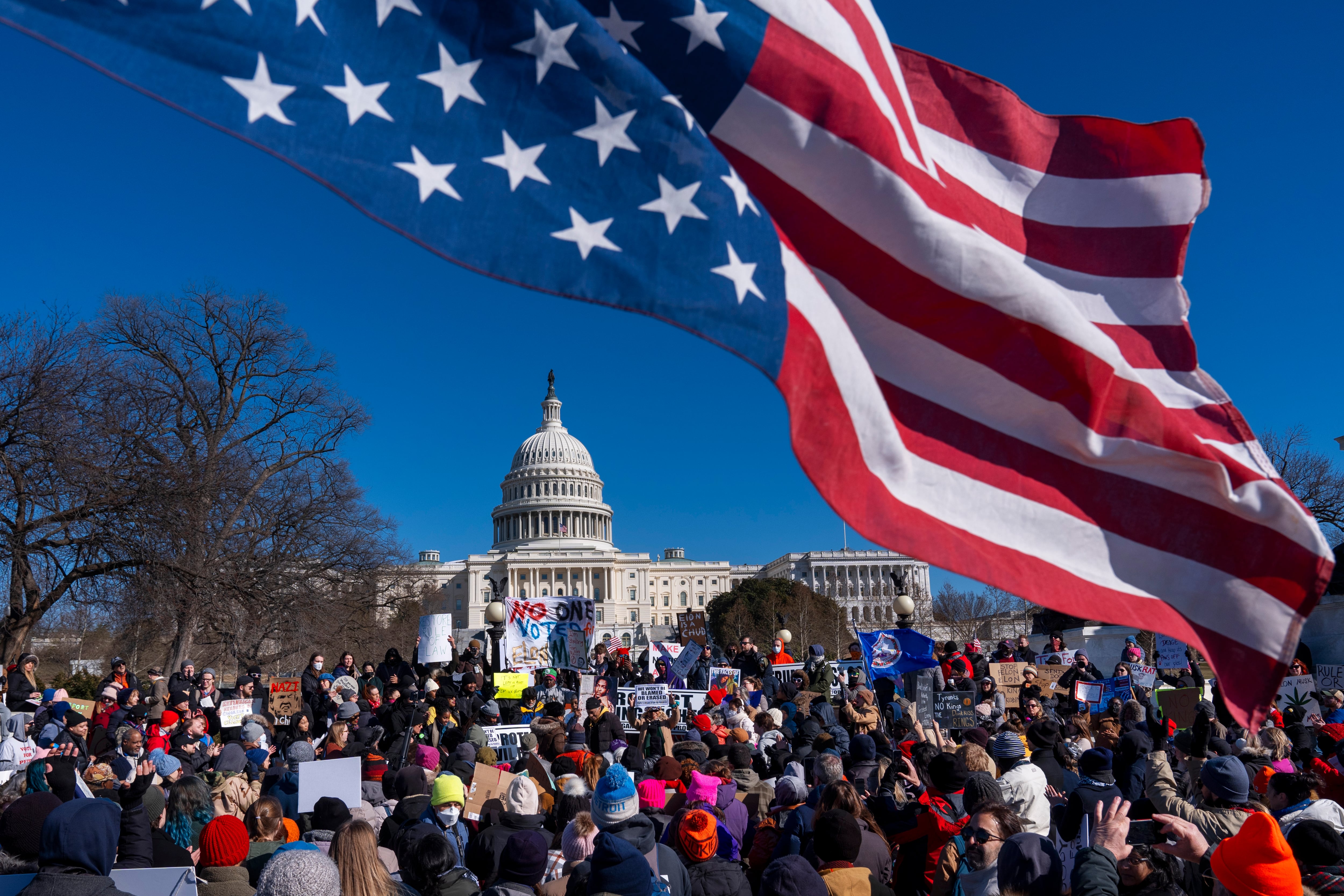 An American flag is flown upside down during the "No Kings Day" protest on Presidents Day in Washington, in support of federal workers and against recent actions by President Donald Trump and Elon Musk.