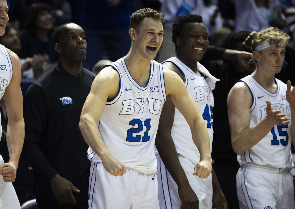Brigham Young guard Trevin Knell (21) celebrates from the sidelines after BYU scored during a game against the Kansas Jayhawks at the Marriott Center on the campus of BYU in Provo on Tuesday, Feb. 18, 2025.