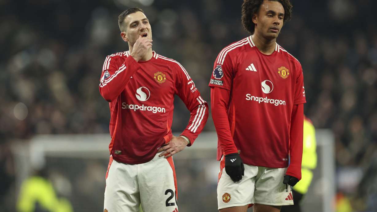 Manchester United's Diogo Dalot, left, and Joshua Zirkzee react after the English Premier League soccer match between Tottenham Hotspur and Manchester United in London, Sunday, Feb. 16, 2025.