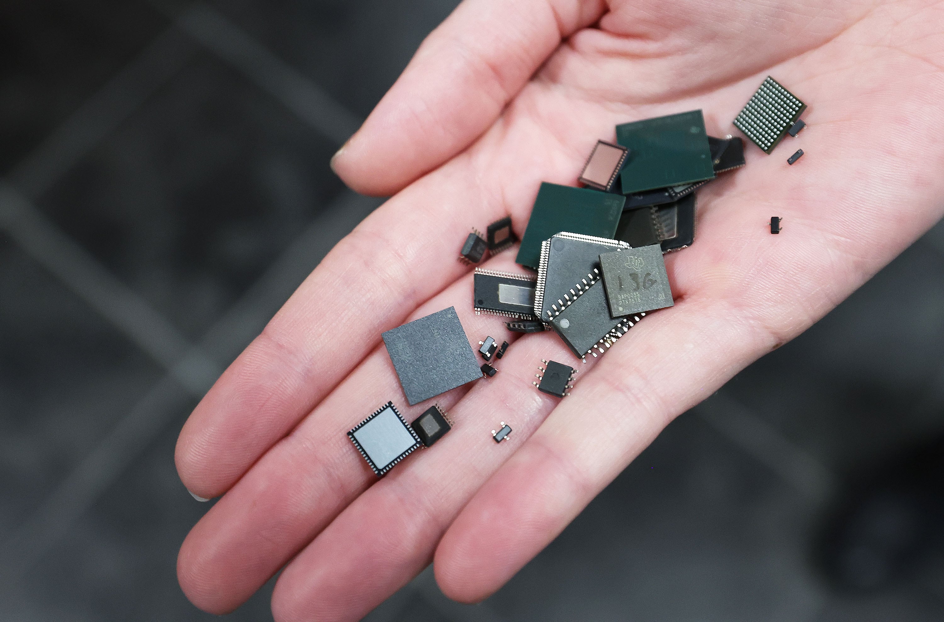 Tiny chips are held at Texas Instruments' newly renovated microchip fabrication plant in Lehi on Dec. 14, 2022.