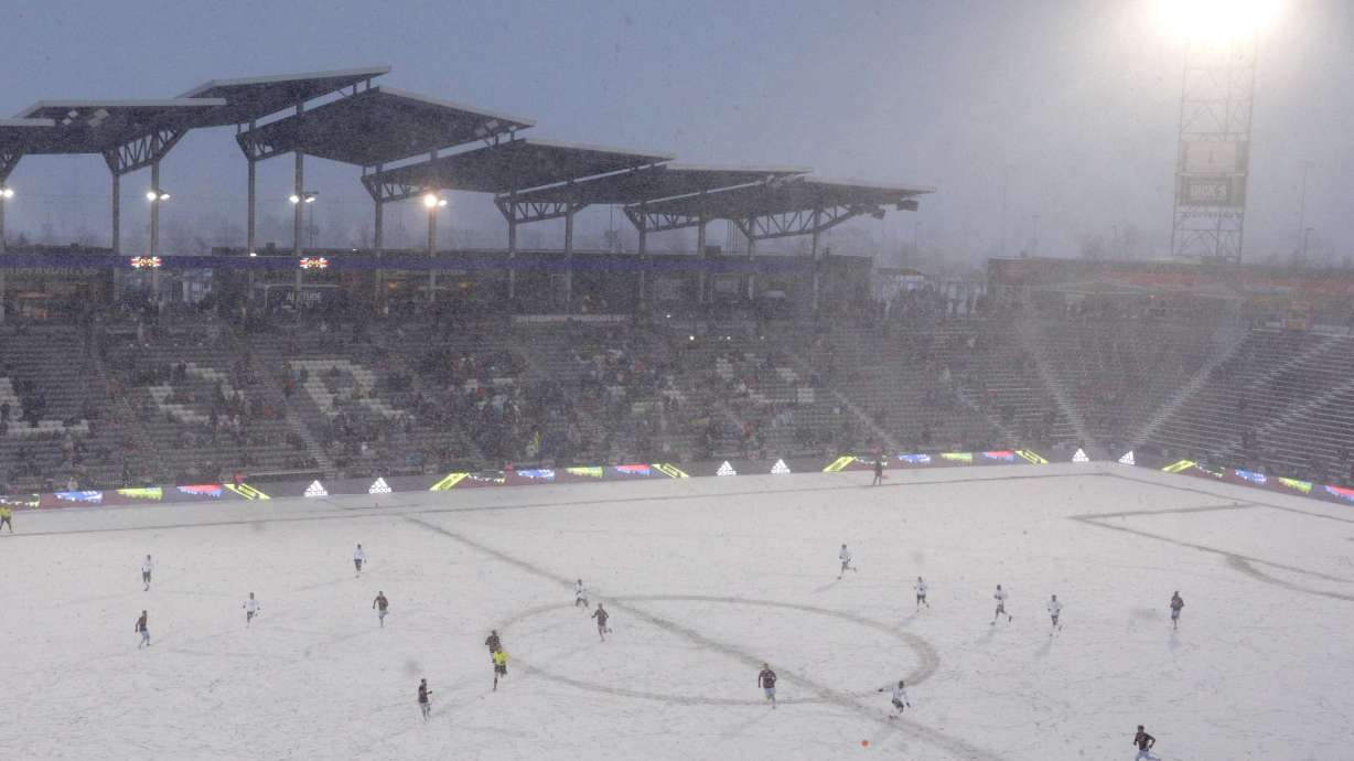 FILE - The Colorado Rapids play the Portland Timbers on a snow-covered pitch during the second half of an MLS soccer game, March. 2, 2019 in Commerce City, Colo.