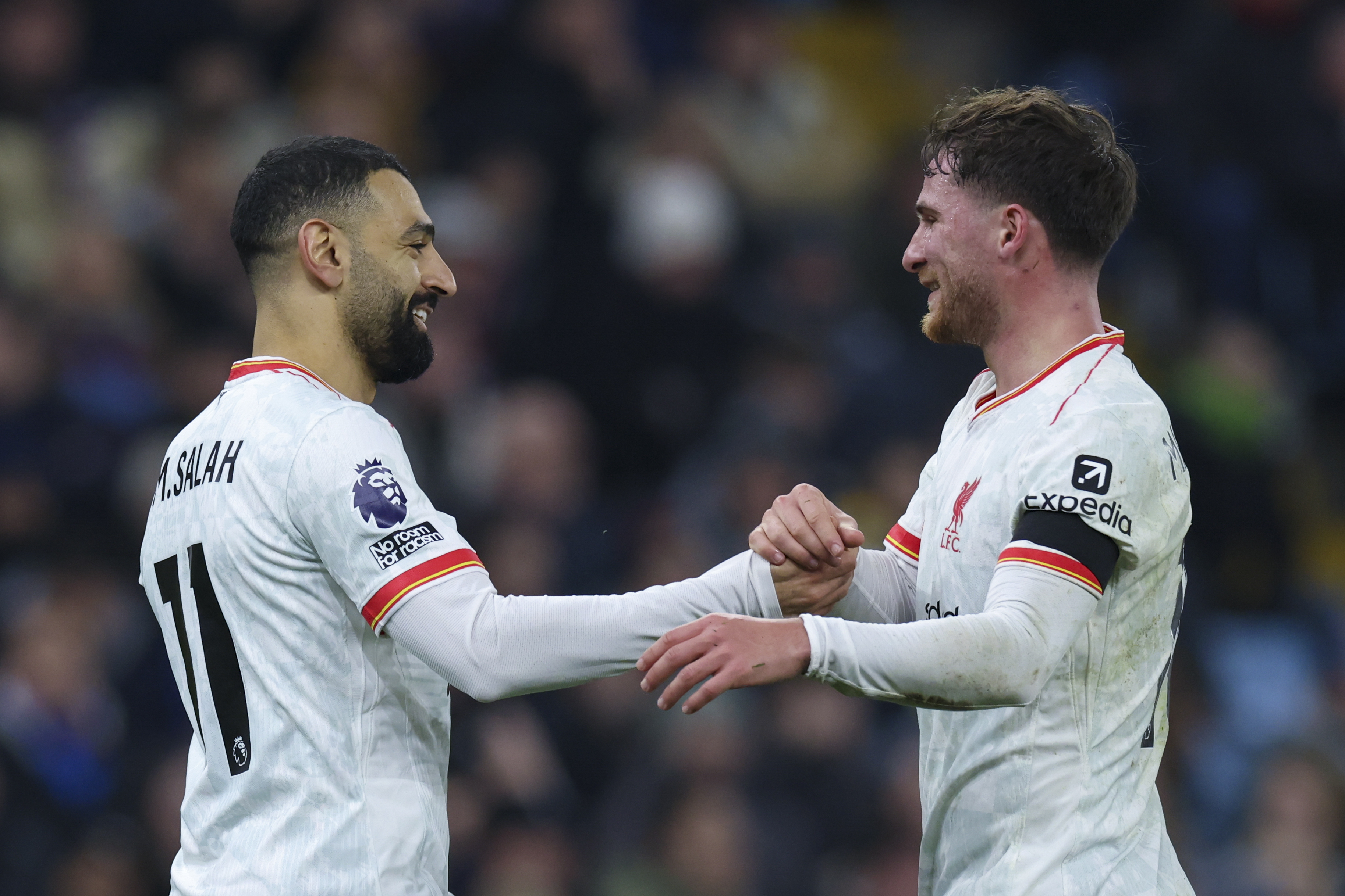 Liverpool's Mohamed Salah, left, celebrates with Liverpool's Alexis Mac Allister after scoring the opening goal during the English Premier League soccer match between Aston Villa and Liverpool at Villa Park in Birmingham, England, Wednesday, Feb. 19, 2025.