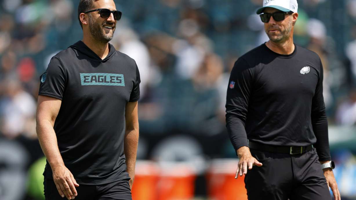 FILE - Philadelphia Eagles head coach Nick Sirianni, left, talks with assistant head coach Kevin Patullo during warmups before an NFL pre-season football game against the Minnesota Vikings, Saturday, Aug.24, 2024, in Philadelphia.