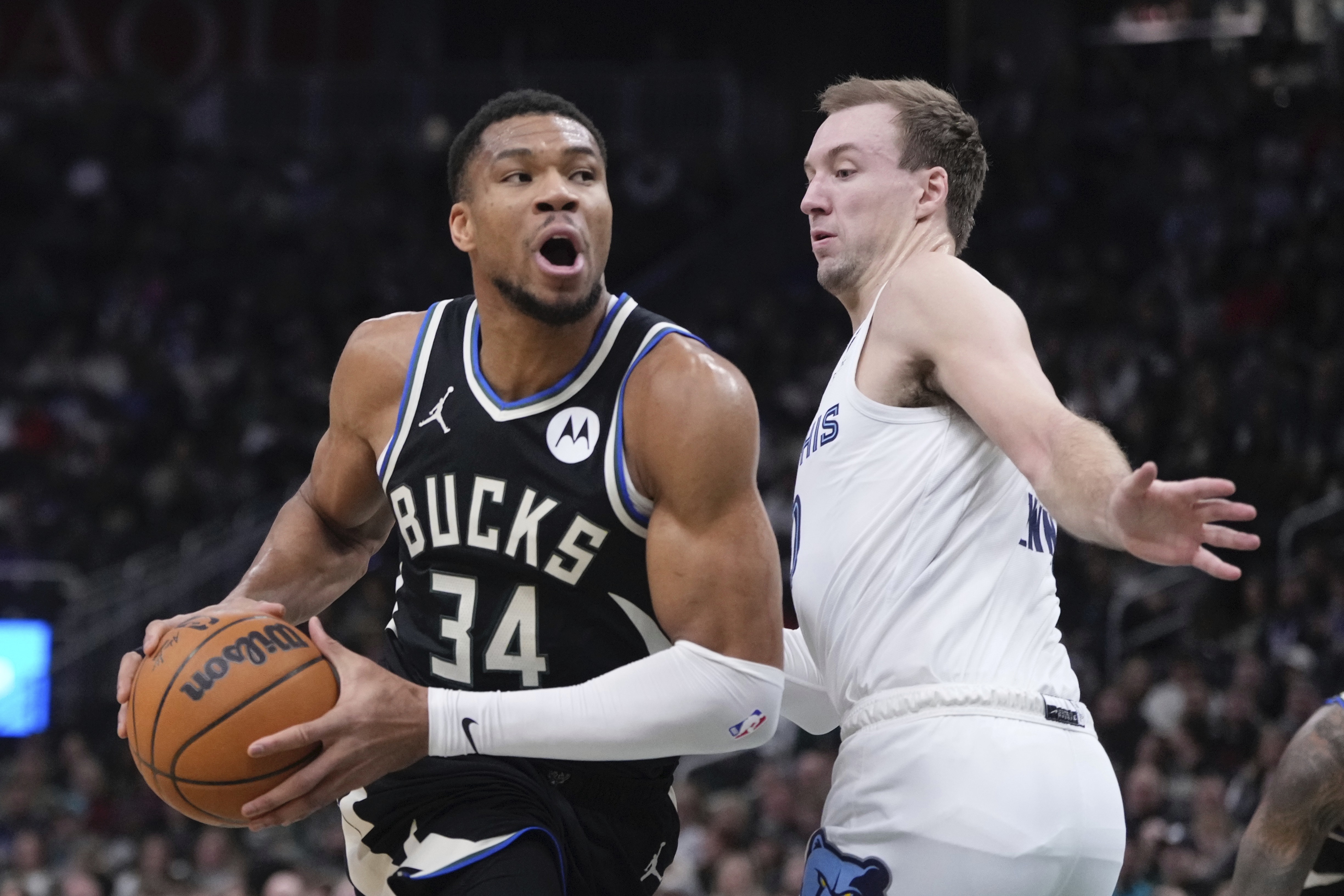 Milwaukee Bucks' Giannis Antetokounmpo tries to get past Memphis Grizzlies' Luke Kennard during the first half of an NBA basketball game Sunday, Feb. 2, 2025, in Milwaukee.