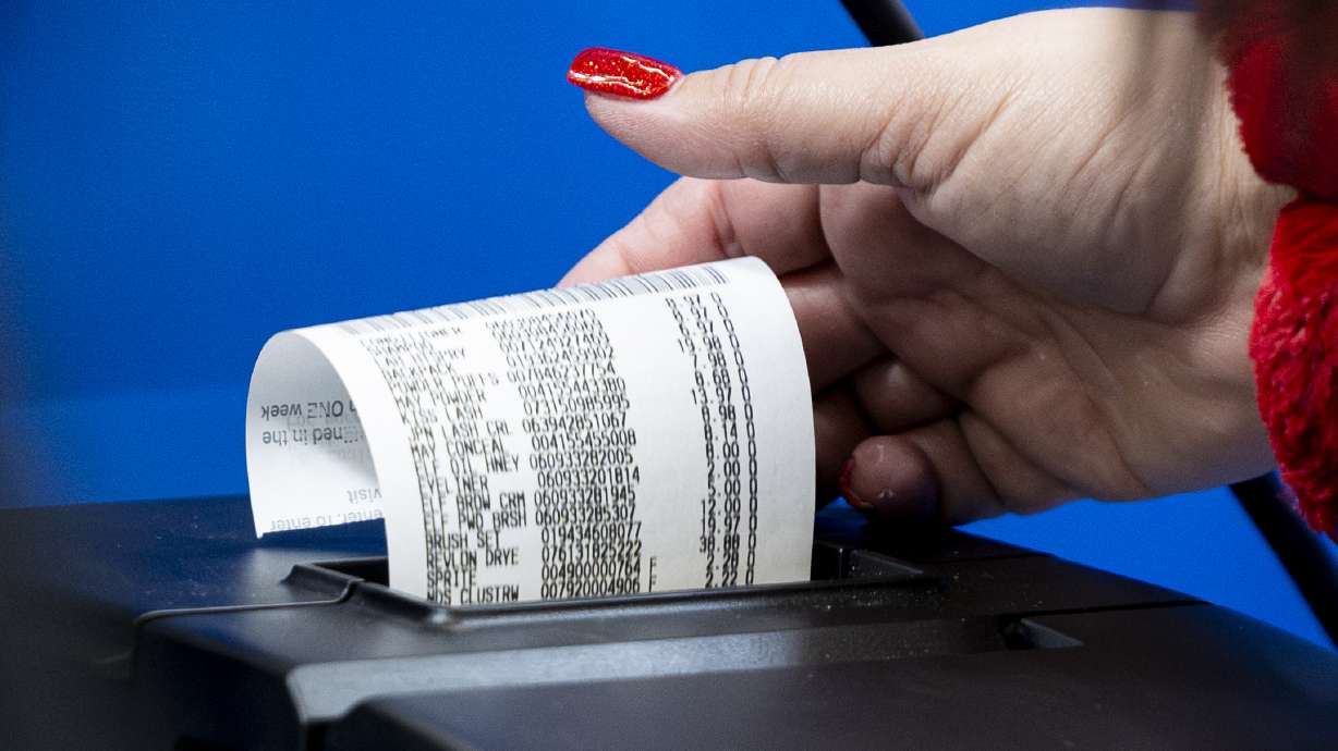 A cashier prints a receipt at the South Jordan Parkway Walmart on Dec. 7, 2024. Even as inflation swells, Utahns generally feel better about their finances and the economy than people in other states.