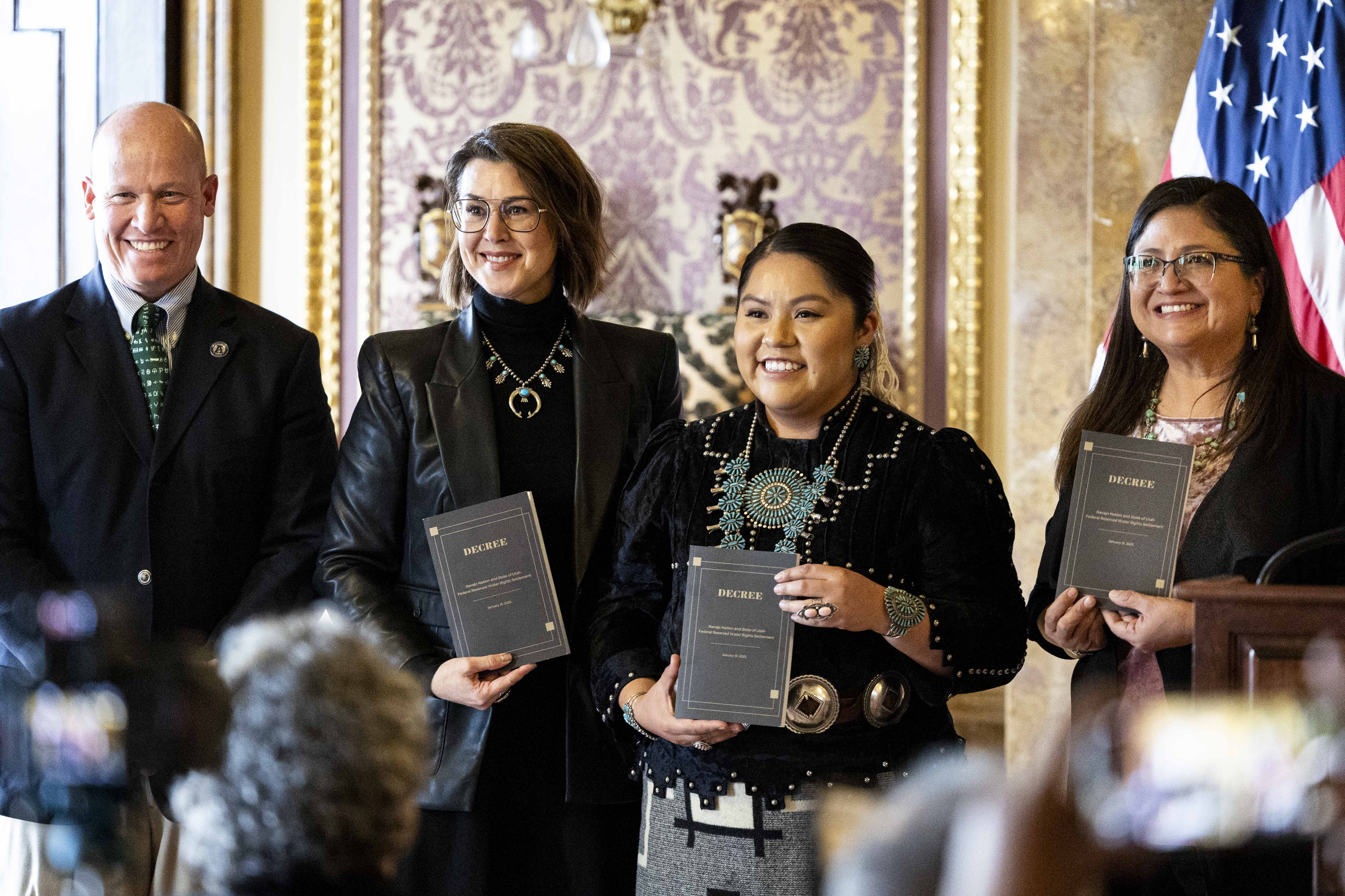 From left, Joel Ferry, Lt. Gov. Deidre Henderson, Shaandiin Parrish and Michelle Espino hold decrees after Utah and the Navajo Nation finalized a water rights agreement in the Capitol in Salt Lake City on Wednesday.