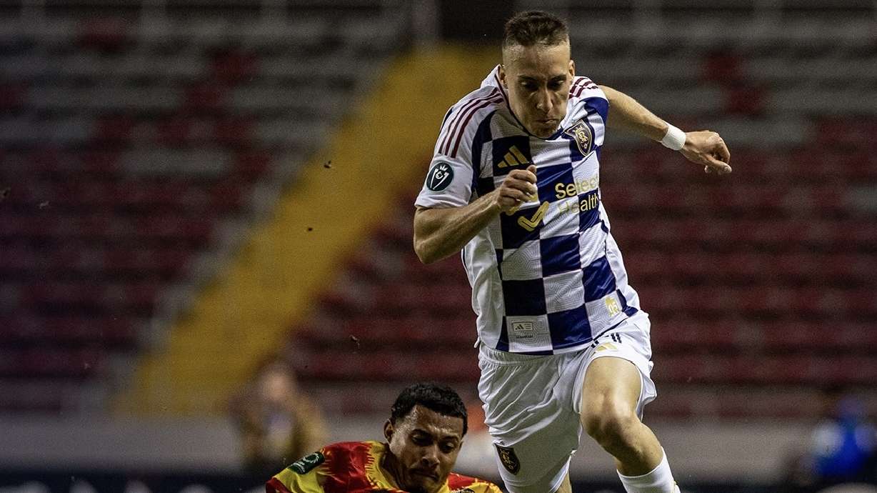 Dominik Marczuk, right, dribbles past an Herediano defender in San Jose, Costa Rica.