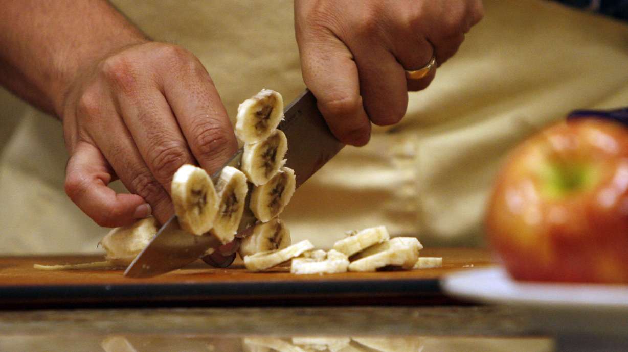 Kent Teichert prepares to fruit for drying, July 7, 2009, in Ogden.