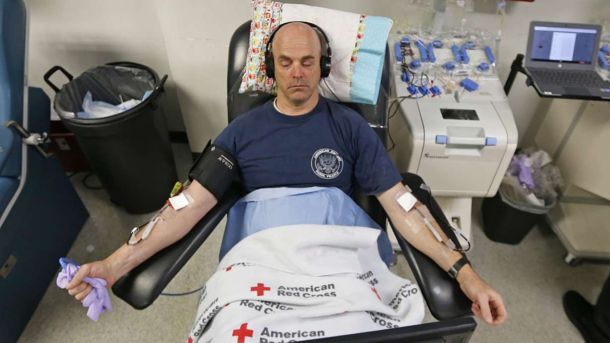 Eric Timpson gives blood at the American Red Cross Donation Center, March 23, 2020, in Murray. Health care facilities in Utah would be required to let patients bring their own blood or choose their own donor for medical procedures under legislation gaining momentum in Utah.